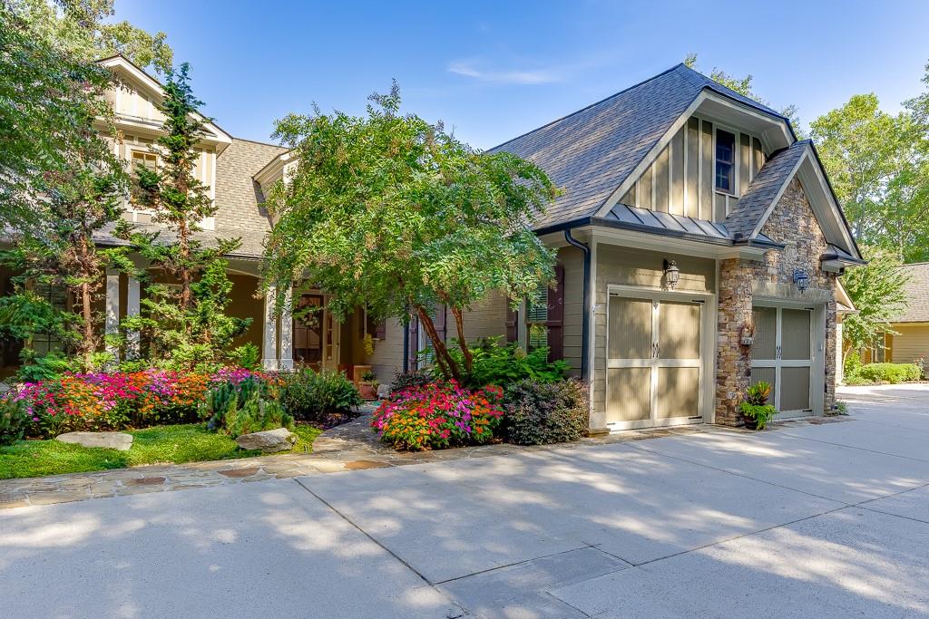 Discover luxury living beyond the greens in this beautifully updated 3-bedroom, 3.5-bath villa located on prestigious Hole #1 of Achasta’s Jack Nicklaus Signature Golf Course. With 3,311 sq. ft. of thoughtfully designed space across three levels — plus additional unfinished square footage in the basement and upper level for future expansion — this home blends comfort, style, and flexibility.
Inside, you’ll find 10-ft ceilings, and elegant 8-ft doors, custom Pella windows with built-in blinds, beamed accents, and built-in bookcases in the loft and media room. The back of the home is lined with endless windows, gleaming hardwood floors, filling the space with natural light and framing beautiful golf course and mountain views from nearly every room. The main-level primary suite offers a spa-like bath with jetted tub and separate shower, coffered ceiling, and large walk-in closet. The chef’s kitchen features a five-burner gas cooktop, stone counters, walk-in pantry, and breakfast bar opening to the fireside family room and sunroom.
The terrace level boasts a media room, wet bar with ice maker and mini fridge, and abundant storage. Step outside to your covered patio with cypress wood ceiling, speakers, Big Green Egg, and hot tub, all overlooking professional landscaping with irrigation, raised garden beds, and private stairs leading directly to the golf course.
Recent upgrades include a new HVAC (2022), roof (2019), water heater (2021), expanded laundry room, fresh exterior paint (2021), and soft wash in 2025 — meaning this home is move-in ready and worry-free.
Additional highlights include an extra-wide parking space designed to accommodate a golf cart, with the golf cart itself included in the sale. A custom wine rack will also remain with the home, offering both functionality and charm.
But life in Achasta is about more than a home — it’s about a lifestyle. Enjoy a vibrant, gated community with an endless array of amenities: four newly resurfaced tennis courts, pickleball courts, a resort-style pool with tiki bar, 3.5 miles of walking trails, River Park with river access for fishing and kayaking, and a clubhouse with restaurant and social events. Plus, Dahlonega’s award-winning wineries and tasting rooms are just minutes away. Every day here is an invitation to explore, relax, and connect with nature — all less than 60 minutes from Atlanta.