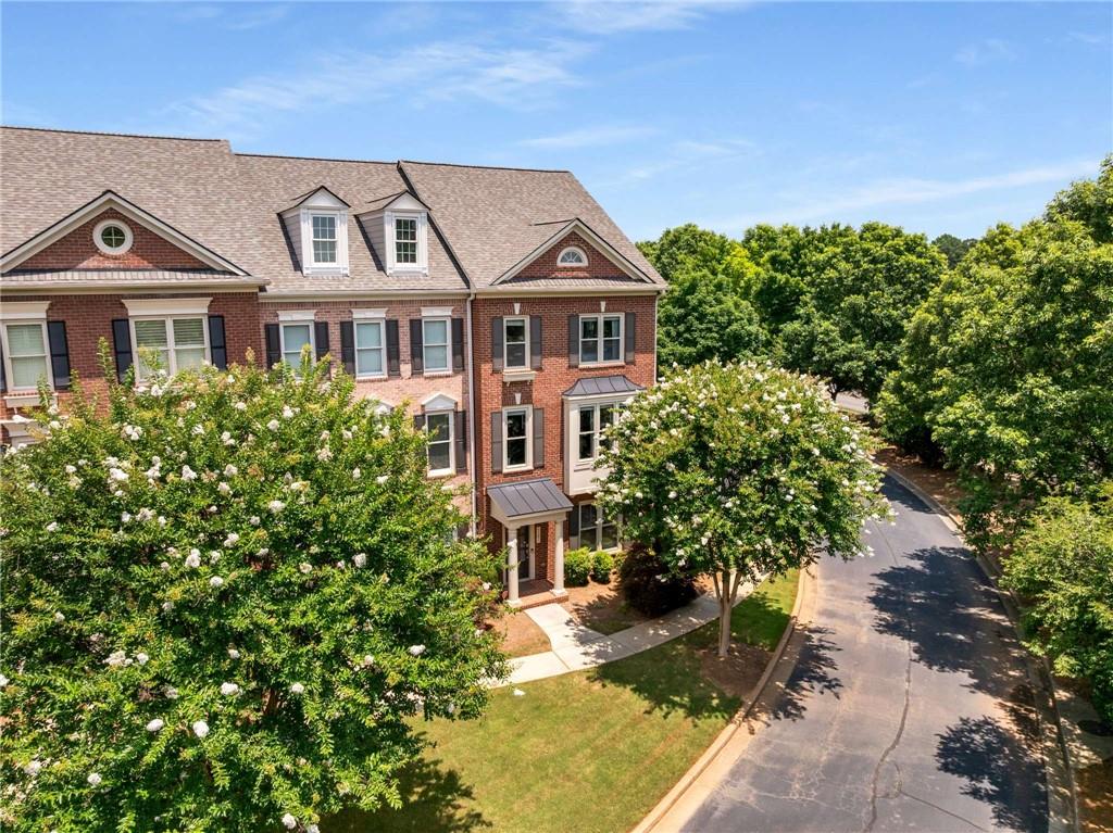 Natural light abounds this beautifully maintained 3-bedroom, 3.5-bath END-unit townhouse with new roof in the sought-after Westwood Park community in Alpharetta. This spacious home features a 2-car garage, hardwood floors on the main level, a light-filled family room with built-ins, and a separate den perfect with a vaulted stained wood ceiling. The kitchen features an island and lots of counter space making this kitchen a cook's kitchen. The open kitchen flows seamlessly to the outdoor deck—ideal for grilling and entertaining. The breakfast room and dining room offers multiple dining spaces. Upstairs, the oversized primary suite offers a walk-in closet, double vanity, and a separate tub and shower. A well-appointed secondary bedroom features a walk-in closet and an ensuite bathroom. Ease of laundry duties are accomplished with the laundry room conveniently located on the upper level. The 3rd bedroom and bath are located on the entry level providing privacy to guests. Enjoy resort-style amenities including a pool, fitness center, catering kitchen, and a stylish club room with a fireplace. All just minutes from Avalon, the Verizon Amphitheater, and top-rated North Fulton schools.