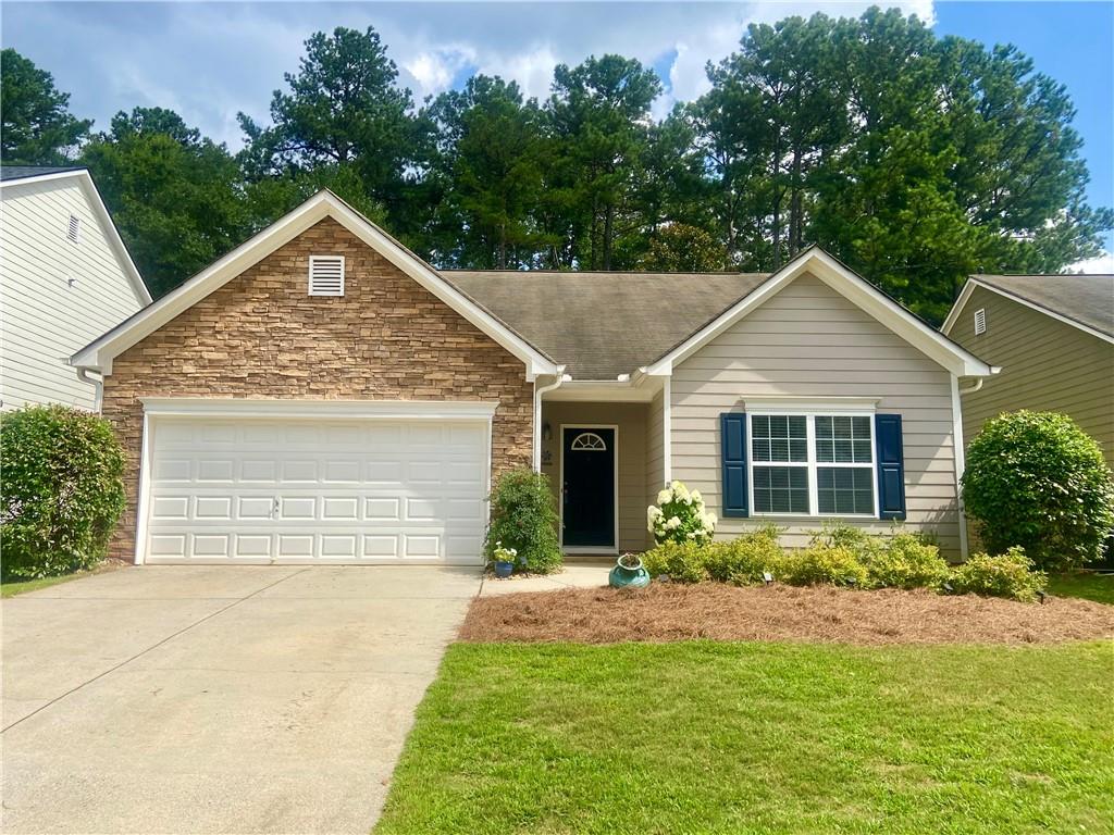 MOVE-IN READY RANCH IN PRIME LOCATION! Welcome to this beautifully updated and meticulously maintained step-less ranch home in the highly sought-after Whitfield at Ridgewalk subdivision. Just a short distance from vibrant Downtown Woodstock, this charming residence offers the perfect blend of comfort, convenience, and community. This 3-bedroom, 2-bathroom home boasts an inviting open floor plan with soaring 10-foot smooth ceilings and an abundance of natural light. The entire interior has been freshly repainted, luxury vinyl plank (LVP) flooring has been installed throughout living areas and brand new carpet installed in the bedrooms. The kitchen features crisp white cabinetry, brand-new stainless steel appliances, and a breakfast bar that opens seamlessly into the living room—perfect for entertaining. Just off the kitchen is a cozy eat-in dining area with sliding glass doors leading to a screened-in patio, ideal for enjoying summer evenings in peace. Step outside to a private backyard that backs up to a serene wooded area—no neighbors behind you! The front yard features attractive, low-maintenance landscaping that adds to this home’s curb appeal. The neighborhood offers low HOA fees, a fantastic swimming pool with a kiddie pool and regular neighborhood social events that foster a true sense of community. Idyllically located near the Outlet Shoppes at Atlanta, numerous dining options, and major roadways (I-575/I-75), this home is also zoned for highly rated schools and benefits from low Cherokee County taxes. Whether you’re a first-time buyer, downsizing, or just looking for a home with convenience and character—this one checks all the boxes. Schedule your showing today!