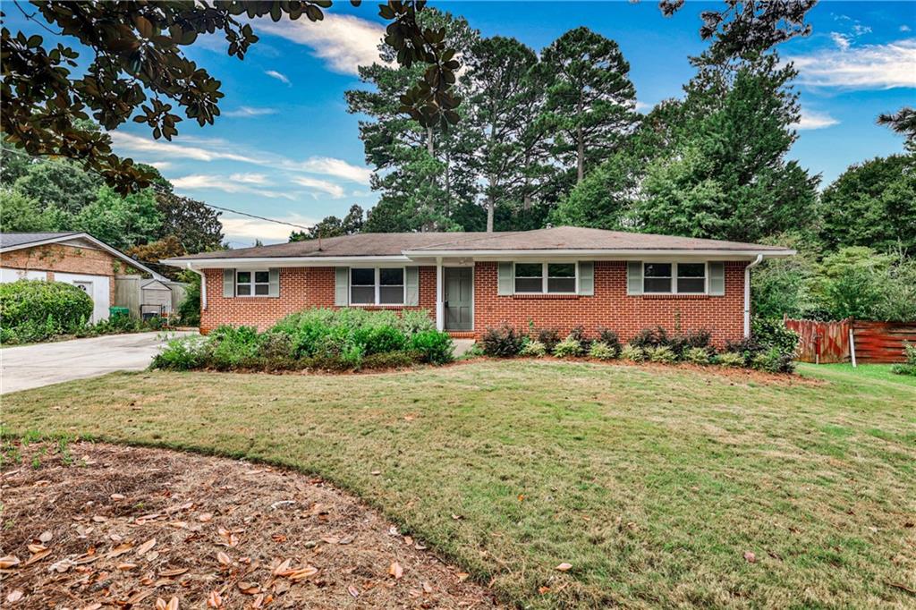 Must see inside. Surprisingly spacious Ranch. This 3-bedroom, 2-bath home offers a well-balanced blend of vintage charm, smart updates,and flexible living spaces-all tucked into a desirable Tucker neighborhood. A generous sized addition creates a light-filled great room, ideal for everyday living, entertaining, or creative use. The spacious updated eat-in kitchen connects seamlessly to the home's living areas, while two skylit rooms invite natural light throughout the day. One, located off the primary bedroom, is perfect for a home office, gym, or private retreat; the other expands the main living space and opens directly to the outdoors. Abundant closet storage-including oversized bedroom closets, hallway storage, and built-ins-enhances functionality without compromising charm. Freshly painted interiors complement the hardwood and tile flooring found throughout the home.Outside, enjoy a private, fenced backyard with a hardscaped fire pit area, and multiple decks offering great spaces for relaxing or entertaining. An extra-wide driveway, enclosed carport with laundry area, and backyard storage shed provide added convenience and utility. This is a home with space and flexibility. Just minutes from parks, schools, shopping and dining, highway and interstate roads access.