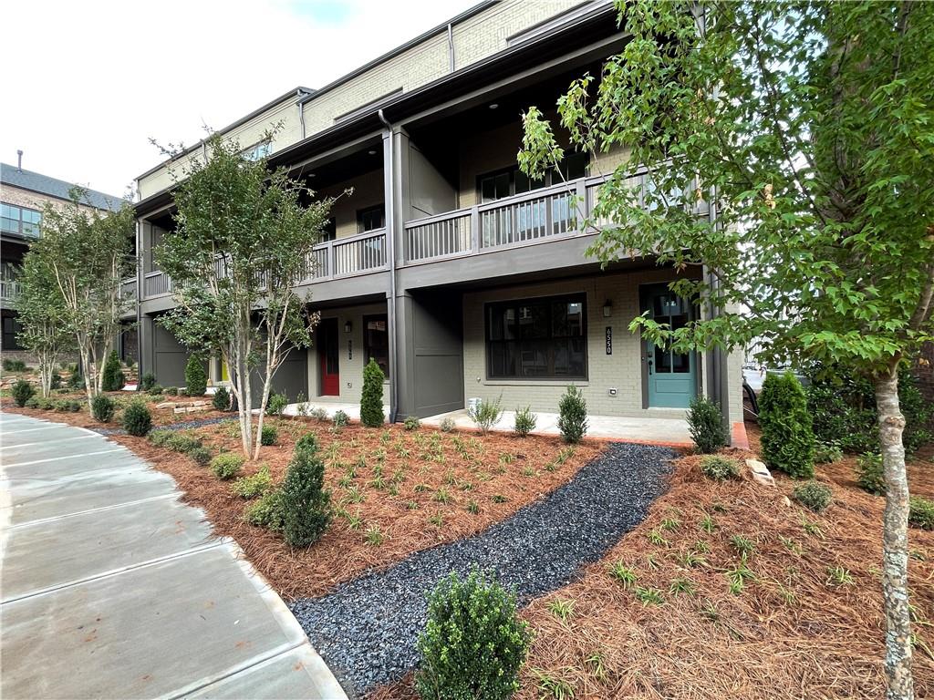 Available now! 3-story townhouse at THE HALCYON. End unit with 8 extra windows. 3 Bedrooms and 3.5 Bath and each bedroom have its own full bath. Unit has covered porch and covered deck and 2 Car garage. Designer kitchen features granite countertop and island, stainless steel appliances with microwave drawer. Master bath with oversized frameless shower with tile bench, double vanity a large walk-in closet. High-end fridge and washer/dryer are included. Paved paths through the open garden, dog park, clubhouse and swimming pool. Walking distance to restaurants and shopping. Greenway entrance 100 feet away. Right off Exit 12 on Highway 400.
