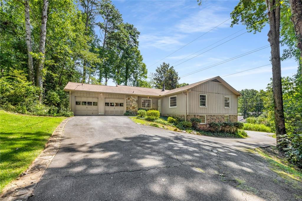 Located in one of the area’s most sought-after school districts—Sope Creek Elementary, Dickerson Middle, and Walton High School—this 1971 ranch presents endless possibilities. This home has strong bones but is in original condition and ready for your special touches. With 4 bedrooms and 3 full baths, including a fully finished terrace level with a second kitchen, this charming home has plenty of space and sits on just shy of an acre. Situated on a quiet cul-de-sac, there's also a 32' by 45' parking pad behind the house, perfect for an RV, boat, or even a sport court! Whether you’re a buyer looking to create your dream home in a premier location, or an investor seeking a high-potential project, this home is the perfect canvas. Listed below recently appraised value, opportunities like this in such a desirable district are rare—don’t miss your chance to make this one your own!