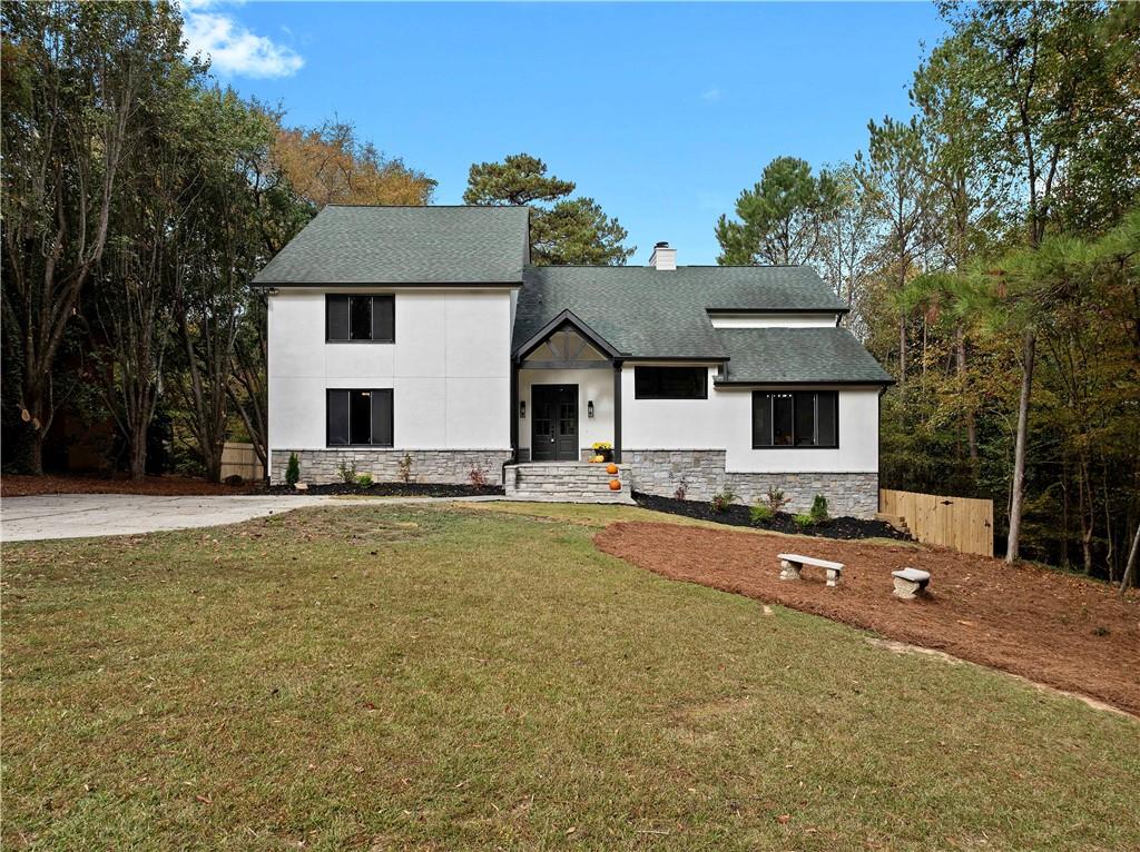 Step Into your Dream Home! Here is an Amazing Opportunity to own this Beautiful Fully Renovated Traditional Modern Style Home in the Highly Coveted Breakwater Community! This Stunning Residence Features 6 Bedrooms w/ 5.5 Bathrooms on a Full Finished Basement and its situated on over a Half Acre Corner Lot. Upon Arrival you will be delighted with the Front yard Space & Landscape & Curb Appeal. Once you Step into the Foyer you be greeted by a spacious Living Space with Brick Fireplace, Custom Built-in Shelving & Natural Lighting. Spacious Bedroom on Main Level w/ Full Bathroom, Lovely Dining w/ wainscoting designs on the walls which flows seamlessly into the Large Luxury Style Kitchen. The Kitchen Features Stunning Quartz Counter-Tops, All White Cabinetry, Range Cook Top w/ Custom Range Vent Hood, Beveled Subway Tile Backsplash & An All New Appliance Package! Upstairs you will fall in love with the Master Bedroom & En suite which offers a Spacious Bedroom / Sitting Area w/ Custom Fireplace. The bath has a Custom Made Double Vanity, Soaking Tub,  Beautifully Tiled Shower & Custom Built-In Walk-in Closet. All Secondary Bedrooms are very Spacious & Bright with Beautifully finished Baths. The Laundry Room Is Amazing with Gorgeous geometric Floor tiles, All White Cabinets, Custom Utility Sink & Butcher Block Counters. The Basement is Fully Finished, Perfect for Entertaining Family & Friends! Oversized Bonus Room w/ Tray Ceiling & Recess Lighting which can be used as an Additional Living Area, Gym, Play Room or even a Media Room. The Custom Dry Bar is Absolutely Gorgeous with Custom Wine Holder Built-in & Stainless Steel Wine Refrigerator, Floating Shelves & Black Beveled Subway tile Back Splash. There is Also a Bedroom & Full Bathroom, An Office, Powder Room & Access to the Backyard from the Basement! All NEW HVAC , NEW WATER HEATER, BRAND NEW INSTALLED PRIVACY FENCE, ALL NEW STAINLESS STEEL APPLIANCES, ROOF IS 5 YEARS OLD!!! Huge Fenced Backyard with Massive Walk Out Deck, Private Backyard with Potential for an In-ground Pool! 2 Car Garage with New Epoxy Flooring. Amazing Community with Great Schools!! Located Close to Interstates & Shopping!!!