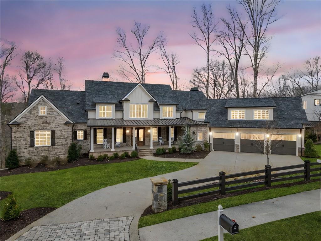 Introducing 310 Timberview Trail, a stunning, newly constructed custom estate nestled within the prestigious Liberty Grove enclave of Milton’s coveted Blue Valley. This exclusive, gated community offers a serene environment with lush green spaces, remarkable amenities, and the added benefit of Cherokee County’s lower property taxes.
Crafted in 2023, this exceptional home features a highly sought-after layout with the primary suite conveniently located on the main level. The home also boasts a spacious laundry and mudroom, an open-concept dining area, an exquisite chef’s kitchen, a private office, and a charming keeping room—all designed to seamlessly blend indoor and outdoor living, with direct access to the expansive covered patio. Set against a backdrop of unparalleled privacy, the beautifully landscaped lot is complete with a pool, hot tub, and multiple outdoor entertaining areas.
Inside, natural light pours into the home through soaring ceilings, accentuating the open-concept design. The chef’s kitchen is a masterpiece, featuring quartz countertops, a generous island, and a premium suite of appliances. A vaulted keeping room with a cozy fireplace offers stunning views of the private backyard, providing an ideal retreat within the home. Exquisite custom woodwork throughout the space elevates the property to a new level of elegance.
The main floor also includes an oversized laundry room, with a secondary laundry space located upstairs. The second level hosts four luxurious ensuite bedrooms, each with spacious walk-in closets, along with an additional loft area for added flexibility.
The fully finished terrace level is an entertainer’s dream, complete with a state-of-the-art theatre room with a 12-foot screen, a fitness center, a recreation room with its own fireplace, and a full bathroom with both a shower and sauna. This level provides direct access to the heated pool and spa, which is perfect for entertaining guests. The outdoor space is wired for an impressive sound system, further enhancing the atmosphere.
Special features throughout the home include a 17 SEER HVAC system, tankless water heaters, 50-year architectural shingles, spray foam insulation for optimal energy efficiency, and low-voltage wiring throughout with home automation capabilities and centralized lighting controlled via wireless internet repeaters.
The pool area is ready for enjoyment, with a stunning custom railing and fire bowls that provide a magical ambiance as the sun sets.