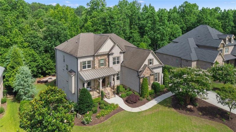 Beautiful custom-built home with a timeless brick and stone exterior in the highly
desirable gated community of Manor North. This expansive home is an entertainers’
dream featuring 6 bedrooms, 5 full bathrooms and a 3-car garage. Enter from the
stacked stone porch through the 8-foot double front doors past the large formal dining
room and living room with fireplace. The floor plan opens to a 2-story family room with
beamed ceiling, fireplace, expansive bay of windows and built-in bookcases. There is
also a bar area and circling back to the dining room a butler’s pantry. The kitchen has a
walk-in pantry, large island with cookbook storage on both ends, pull out cabinet
drawers, double ovens and a professional 6 burner gas range. Open to the kitchen is a
breakfast area with 3 walls of windows or doors that puts you in mind of a tree house.
Outside is a large deck equipped with a gas grill overlooking the lush, private backyard.
The main level also includes a guest suite or office and a guest bath and a mudroom
leading out to the garage.
Upstairs features the private master suite with coffered ceiling, ensuite bathroom with
double sinks, soaking tub and walk in shower, a huge walk in closet and secondary
closet. In addition, there are 2 bedrooms with a full hall bath, and an oversize 4th
bedroom with an ensuite bath. The laundry room is also upstairs convenient to the
bedrooms.
The terrace level is finished with a media room, rec room, large gym, office or bedroom,
full bath with walk in shower, custom bar area with ice maker and wine refrigerator and
large storage area. Outside there is a large, covered patio under the deck and
breakfast room. The backyard also features a large firepit area.
Top ranked schools, shopping and dining only minutes away, this active community
features a large clubhouse, Olympic and kiddie pools, 4 pickleball courts, 3 tennis
courts and lower Cherokee county taxes.