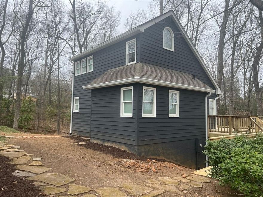Great location mins to Halycon,Ga 400 and the greenway. Charming Cottage-Style home nestled on a serene, one-acre wooded lot, this charming 3-bedroom, 2-bath . A true hidden gem, it feels like a private retreat while still providing all the conveniences of home.The beautifully updated kitchen features top of the line applanices, while the spacious great room boasts soaring ceilings, creating a bright and inviting living space. The main level also includes a full bathroom with a stunning tiled shower. Upstairs, the loft-style primary bedroom overlooks the main floor and includes a full bath and a walk-in closet. The finished basement provides additional bedroom and storage, a cozy fireplace, and versatile flex space—ideal for a home office, guest area, or second living space. Step outside to embrace the beauty of nature from the expansive wrap-around deck. The home’s peaceful and private setting, making it the perfect place to unwind and enjoy wildlife.