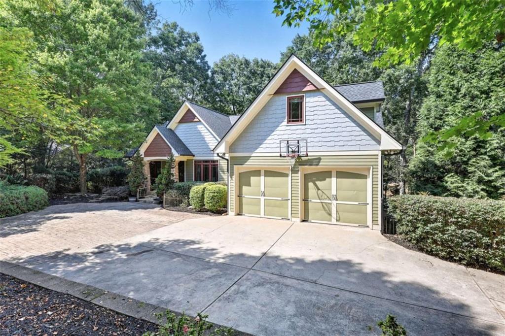 Welcome to this beautiful craftsman-style home with a charming cabin feel! Inside, you'll find warm, rustic finishes and plenty of flexible living space. Master is on Main, plus two additional bedrooms and a shared bath. An expansive deck with an outdoor fireplace creates the perfect spot for relaxing and enjoying seasonal views of Lake Lanier. Downstairs, the finished basement offers a media room with a closet and window that can serve as an additional bedroom, along with a large bonus room that can double as another sleeping space. With two full kitchens and two full laundry rooms-one on each level-this home is perfectly set up for a mother-in-law suite, multi-generational living, or extended guest stays. Outside, you'll find a picturesque koi pond and waterfall, adding to the home's serene ambiance. A private lower-level courtyard with a fire pit offers even more outdoor enjoyment. Plus, the property boasts a brand-new roof and has been meticulously maintained, making it move-in ready. To top it off, this home is nestled in a wonderful Lake Lanier community with a convenient boat ramp just around the corner, offering easy access to all the fun and recreation the lake has to offer.