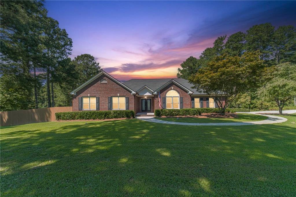 Discover this incredibly special and lovingly maintained property! Bring your RVs, campers, or boats, start a beautiful garden, or even run your own home-based business-imagine advertising right from your front yard on this amazing corner lot with so much road frontage! Set on over 1.79 acres of stunning land, it features an attached two-car garage and a separate driveway leading to a spacious 2,000 sq ft garage with power, mini-split heating and cooling, water, 220 volts, an office space, and extra parking for two cars. There's also a large boat door perfect for two boats. Best of all, there's no subdivision or HOA! Ideally located just 3 miles from Harbins Elementary and 1 mile from Harbins Park, you'll enjoy playgrounds, pavilions, grills, a scenic 4.3-mile paved trail, trails for horseback riding, mountain biking, and hiking, plus a football/multi-purpose field with a lighted walking trail, river channel, lake, and a seven-field baseball/softball complex with batting cages. Nowhere else will you find such a peaceful retreat at home while still being close to so many amenities. From a park-like yard to charming iron castle doors, this property is sure to wow your guests. Inside, you'll feel warm and welcomed-as cozy as being wrapped in your favorite blanket. Upgrades and updates include fresh neutral paint, new flooring, elegant iron doors, custom blinds throughout, tray ceilings with exquisite four-sided crown molding, walk in closets in all bedrooms, electric Nest security cameras, a whole-house Generac gas-powered generator, an oversized gas meter, a new tankless water heater, and enhanced curb appeal. Beautiful hardwood floors lead you from the inviting foyer to the spacious family room with a brick fireplace and tray ceiling, then into the formal dining area, and finally to the chef's eat-in kitchen with stained cabinets, a pantry, a center island, a separate gas cooktop, and a combo wall oven/microwave. The fantastic laundry/mudroom offers a utility sink, plenty of storage, and workspace. The main floor also features two guest bedrooms, a full bathroom, and a powder room. The large primary suite boasts double tray ceilings and an en-suite with a double vanity and a luxurious, Jacuzzi, European-inspired walk-in shower with multiple shower heads and a shower bench-perfect for relaxing after a busy day. Upstairs, the bonus room serves as the fourth bedroom and is a wonderful, versatile space for teens, homeschooling, or a home office. It has it's own minisplit system for heating and air! Enjoy peaceful moments on the screened-in porch that opens onto a two-tiered deck overlooking a lush yard filled with peach and apple trees. Allow yourself or the kids to let loose in the fenced backyard with your furry family members. Plus, three solar-powered greenhouses with motorized rain barrels make gardening fun all year round. Get ready for football parties, fall bonfires, festive Christmas decorations, and a winter wonderland-this is the dream home you've always wanted, now within reach. Stop dreaming and start living your dream!