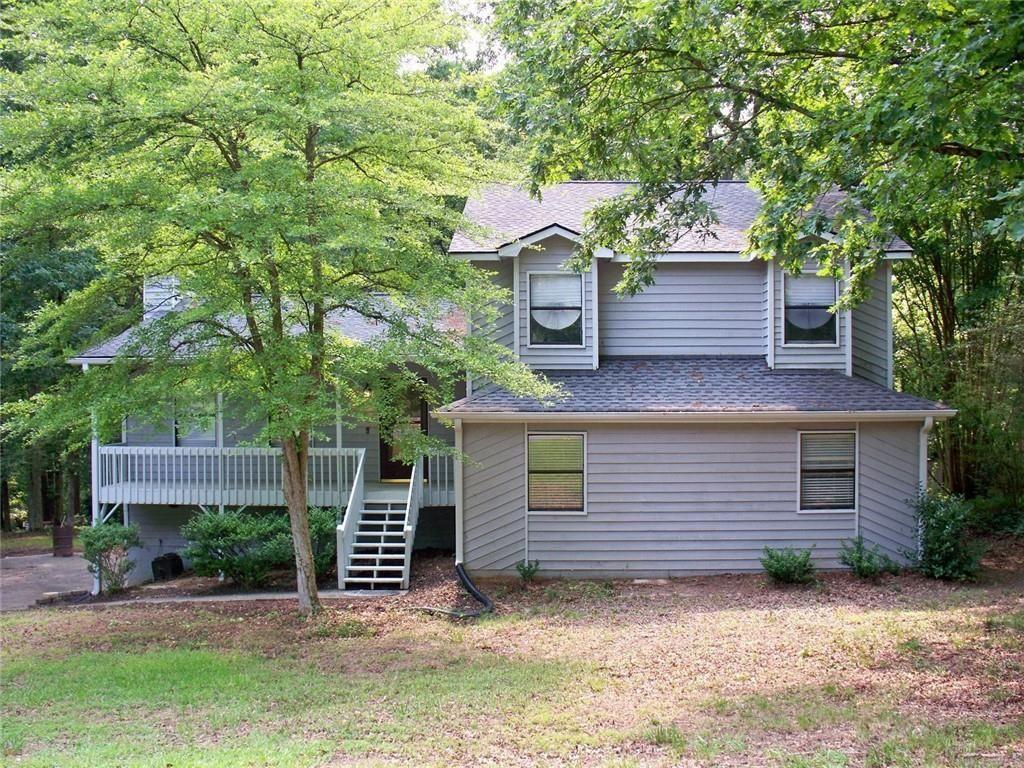 Welcome to your beautiful and spacious split-level home. This home offers an oversized living room that has gorgeous new LVP flooring and a stone fireplace to the ceiling, perfect for entertaining. As you go to the upper level you will find three large bedrooms all with new carpet. Both bathrooms have tile flooring along with a jacuzzi tub in the master bath. Down a few steps off the main level, you will enter the spacious kitchen and breakfast area with hardwood flooring and granite countertops, stainless steel appliances including a new refrigerator and beautiful cabinets. Also included on this level is a half bath and separate laundry room as well as a huge bonus room which can be used for a myriad of purposes. Running along the back of the house is a private two-tiered deck that is accessed from the living room and kitchen. You will feel the serenity as you step out on to your deck looking out over a wooded area that is part of the Dupree Park. No HOA and a large level lot makes it even better. With your location just 2 miles from downtown Woodstock and all that it has to offer including the Amphitheater and great restaurants, shops and nightlife you will love your new home. Minutes to 575 and Hwy 92/Arnold Mill, also close to Roswell, Milton, Cobb and Canton.