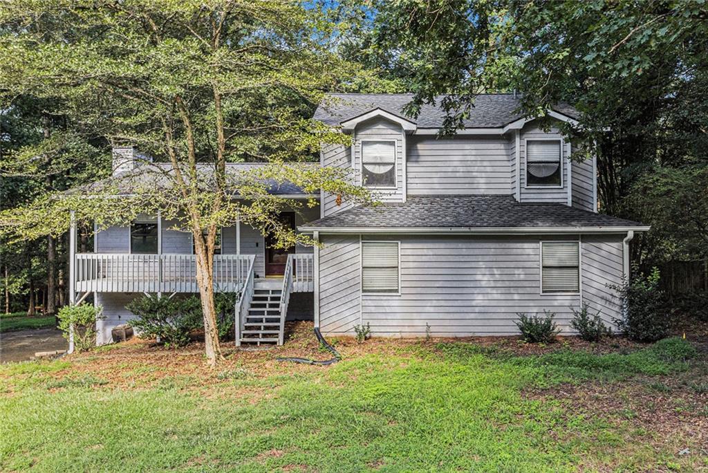 Welcome to your beautiful and spacious split-level home. This home offers an oversized living room that has gorgeous new LVP flooring and a stone fireplace to the ceiling, perfect for entertaining. As you go to the upper level you will find three large bedrooms all with new carpet. Both bathrooms have tile flooring along with a jacuzzi tub in the master bath. Down a few steps off the main level, you will enter the spacious kitchen and breakfast area with hardwood flooring and granite countertops, stainless steel appliances including a new refrigerator and beautiful cabinets. Also included on this level is a half bath and separate laundry room as well as a huge bonus room which can be used for a myriad of purposes. Running along the back of the house is a private two-tiered deck that is accessed from the living room and kitchen. You will feel the serenity as you step out on to your deck looking out over a wooded area that is part of the Dupree Park. No HOA and a large level lot makes it even better. With your location just 2 miles from downtown Woodstock and all that it has to offer including the Amphitheater and great restaurants, shops and nightlife you will love your new home. Minutes to 575 and Hwy 92/Arnold Mill, also close to Roswell, Milton, Cobb and Canton.