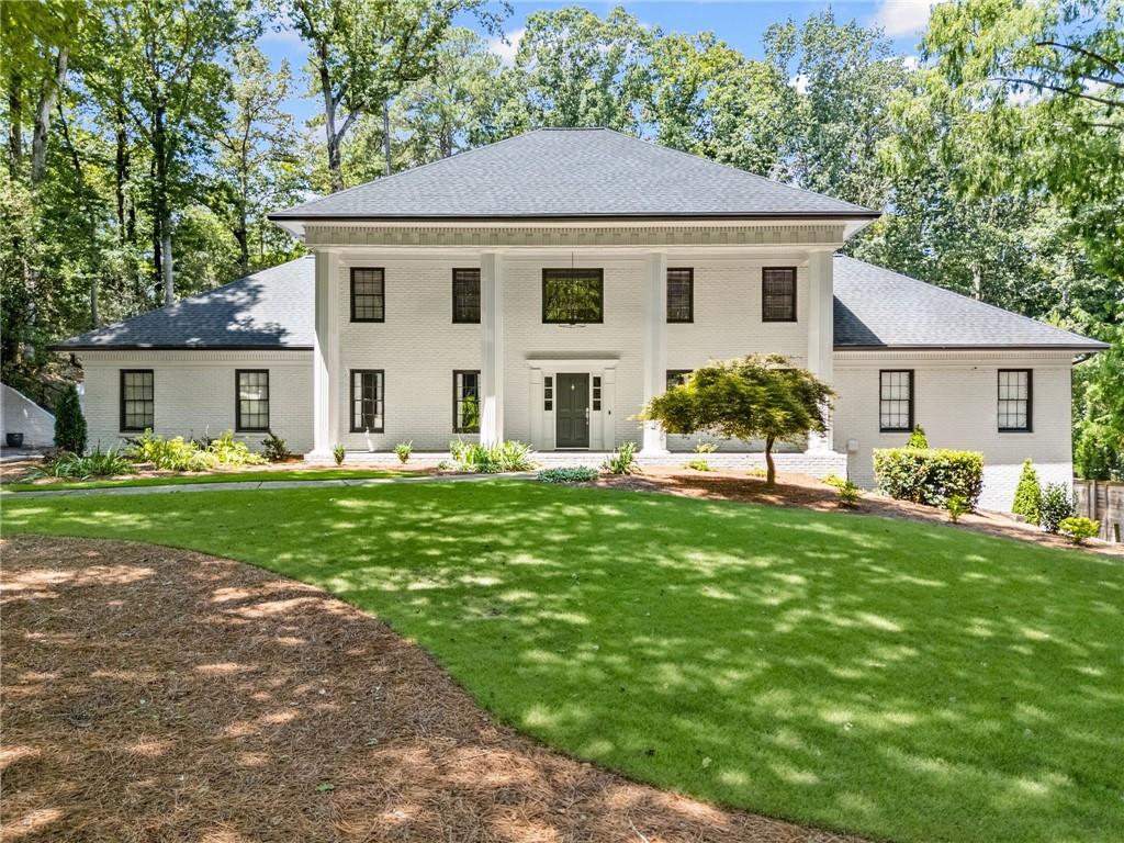 Welcome to 8120 Habersham Waters Road, a stunningly renovated home where timeless elegance meets modern luxury. Nestled on a 1.01-acre private, wooded lot in the prestigious and socially vibrant Rivergate community of Sandy Springs, GA 30350, this residence offers over 5,100 square feet of refined living space. Featuring 4 spacious bedrooms, 4.5 bathrooms, and the rare advantage of dual primary suites - one on the main level and another upstairs - this home is perfect for multigenerational living or those with flexible lifestyle needs. At the heart of the home, the fully renovated chef’s kitchen is a true showpiece. Custom cabinetry complements a professional-grade Wolf range and microwave, a Miele built-in refrigerator and dishwasher, and a trash compactor for added convenience. Opened seamlessly to the family room, the space offers a bright, flowing layout ideal for both entertaining and relaxed everyday living, all while showcasing beautiful views of the private, lush backyard. Just off the kitchen, the mudroom features a built-in doggy bath, and hardwood floors run throughout, adding warmth and sophistication. Upstairs, you’ll find three large bedrooms, including the second primary suite with a gorgeous spa-like bathroom featuring a soaking tub, walk-in closet, and an adjoining flex space - perfect for a home office, sitting area, or your dream-dressing room. A spacious upstairs laundry room adds functionality, while all bedrooms feature generous walk-in closets. The private backyard has been transformed into a resort-style retreat, featuring landscape lighting, a completely renovated saltwater pool with integrated hot tub, new pool deck, fire pit, sport court, and composite decking for stylish outdoor dining and lounging. Recent updates include a new irrigation system, fresh landscaping, upgraded lighting, and an exceptional drainage system for beauty and functionality year-round. The yard is fully fenced for privacy and security, with an invisible fence surrounding the entire property perfect for pets to roam safely. The finished daylight basement offers a custom bar, gym, media/game area, full bathroom, and a private office, easily convertible into an additional guest bedroom. Recent updates include a new roof, gutters, and a freshly painted exterior, ensuring the home is as pristine on the outside as it is on the inside. Living in Rivergate is more than owning a home - it’s about joining a vibrant, welcoming community known for its festive holiday parties, book club, and women’s wine nights, providing ample opportunities to connect with neighbors and enjoy an active social lifestyle. This is a rare opportunity to own a move-in-ready, resort-style home with privacy, luxury, and exceptional design in one of Sandy Springs’ most sought-after neighborhoods.