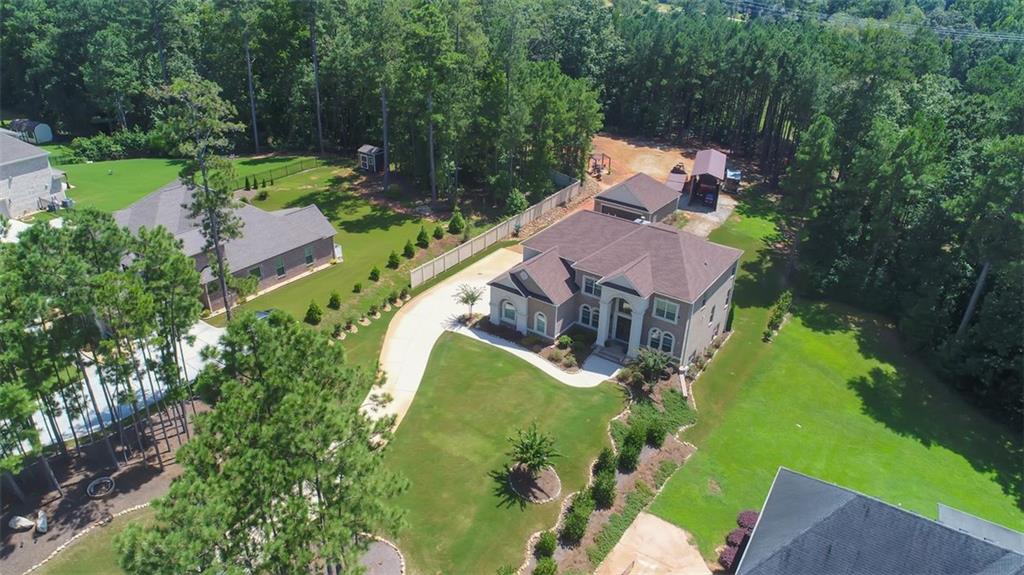 Step into an unparalleled realm of possibilities at 3238 Ashmore Court! Designed for the most discerning of buyers, this property features 5 bedrooms, 4.5 bathrooms, 3 car attached garage with an additional detached 2 car garage and meticulously landscaped grounds with an irrigation system. Everything you desire on one acre with the OPTION TO PURCHASE MORE ACREAGE! The estate also includes an RV/ATV/trailer/boat shed to house all of your outdoor toys and machinery, offering the perfect blend of seclusion and accessibility. Be welcomed by a grand two-story foyer into the main level, gleaming with natural light. The two story family room looks onto the chef's kitchen with an abundance of storage. Off the kitchen you'll be drawn out to a covered retreat featuring a cozy fireplace, perfect for entertaining. Surround sound through out the home and attached garage. Spacious bedroom and bathroom on main floor with an additional half bath. Upstairs host two secondary bedrooms, a full bathroom, one ensuite bed and bath, a laundry room and a palatial owner's ensuite with a jacuzzi tub and an enormous closet that will blow your mind! All atop a full basement. Buyer has the ability to purchase more acreage if desired. Don't miss out on this opportunity, call the listing agent to schedule a tour of this beautiful home.