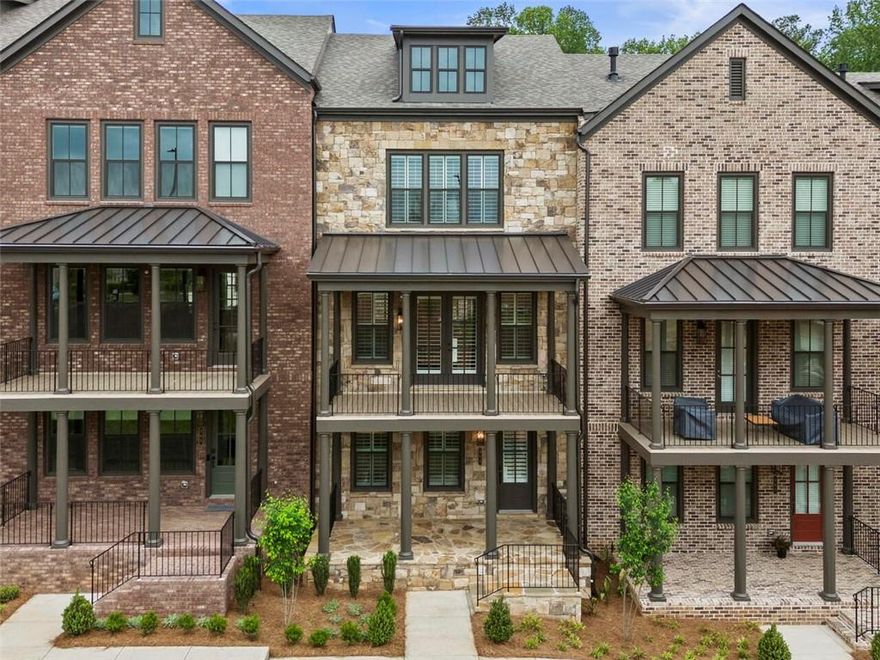 Moments from Avalon, and easy access to the heart of downtown Alpharetta, and connection to the Alpha Loop, this uniquely handcrafted stone townhome imparts an old-world feel, while offering modern and contemporary finishes and luxury design. With shops, restaurants, and entertainment options all at your door, Chiswick is the sweet spot between historic charm and modern living. The first floor features a bedroom perfect for an office or in-law suite with a full bathroom. The second floor features a spacious family room with fireplace opening out to your extra deep, covered porch with views of Avalon, a chef’s kitchen with high end stainless steel appliances, 42” stained/painted cabinets featuring soft close doors/drawers, an oversized island for gathering, a walk-in pantry alongside the butler’s pantry, and a dining room perfect for entertaining. The third floor features a generous Primary Suite with a large walk-in, custom-designed closet, a spacious bathroom with luxury tile, a large walk-in shower with bench and a lavish soaking tub. A laundry room and two secondary bedrooms that share a full bath complete this level. Elevator shafts on each floor allow for plenty of additional storage space. Move-in ready with washer, dryer, fridge and window coverings. Welcome home!