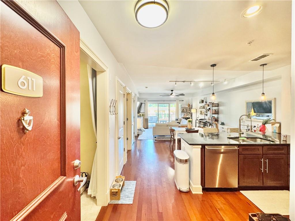 Welcome home to this beautifully upgraded condo featuring a versatile office/den that can also serve as a nursery. The chef’s kitchen is designed with custom cabinetry, deep utility drawers, expanded countertops, built-in wine storage, and premium stainless steel appliances. Enjoy hardwood floors in the living room, where sliding glass doors open to an oversized covered balcony with breathtaking treetop views. The spacious bedroom includes a custom walk-in closet with elegant glass doors, built-in drawers, and ample hanging and storage space for your entire wardrobe. One River Place offers 24/7 guarded security and a dedicated concierge service. Community amenities including EV charging stations, two deeded parking spaces (one covered, #318, and one open, #461), and a clubhouse with concierge desk, coffee bar, game room, fitness center, massage room, and conference room. Outdoor features include a fire pit with grill and Big Green Egg, two salt water swimming pools (one heated year-round), and access to bike and kayak storage in the main garage with private river launch. Residents also enjoy scenic walking trails and a dog park, perfect for meeting fellow pet owners.