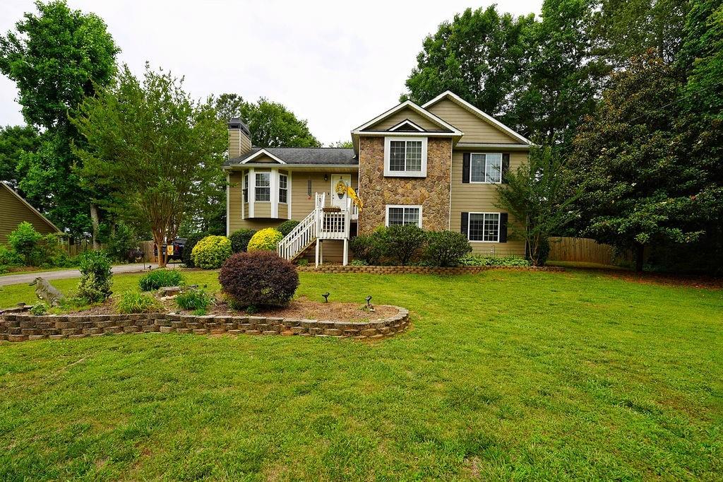Come see this beautiful home in the quiet community of Waverly Hills. Relax in the newly installed 22ft above ground pool in the privacy of the large, fenced backyard. Enjoy the string lights under the deck for those evening swims. This is also a great house to have a BBQ on the huge 12x24 deck that overlooks the pool. This home boasts 4 bedrooms and 3 bathrooms with a living room on each floor. The home sits on nearly a full acre of land that is level and beautifully landscaped. There is a great 11x16 outbuilding with cement board siding that matches the house. Alongside the outbuilding there is a large cement pad where you can park your RV or boat, so bring your toys! This section of Waverly Hills has no HOA so there are no annual fees. Northside Cherokee hospital, tons of shopping and restaurants are only minutes away.