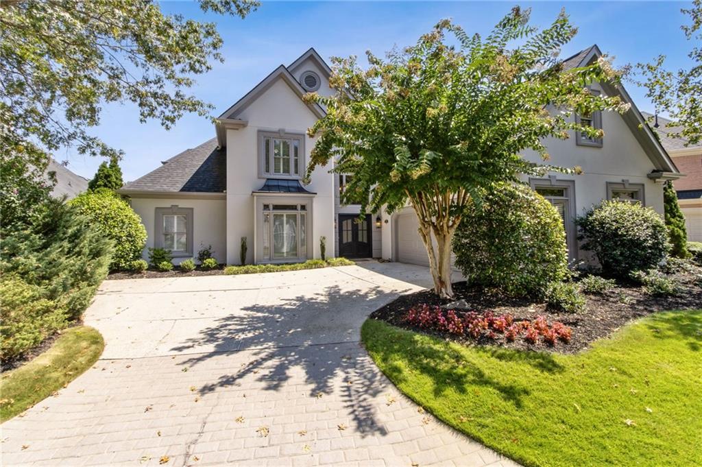 Very special property in the stunning community of Ammersee Lakes on the Chattahoochee River. First time on the market. Beautiful European-style lakefront home with an open floor plan, great for entertaining large and small groups or cozy evenings by the fireplace. High ceilings and walls of windows with breathtaking views of the lake make the natural surroundings a part of everyday life. The front approach to the home features a courtyard entry, garage, and iron double entry door into a 2 story foyer crowned by a wrought iron chandelier. The foyer is open to a spacious dining room and a great room with volume ceiling, fireplace, and a wall of dramatic arched windows viewing the lake. The recently updated kitchen with a breakfast bar, dining area, and a wine bar is open to the family room with a fireplace, built-in shelves, and lake view. The primary suite located on the main level features a high tray ceiling, wall of windows with a lake view & a door to the waterside patio. The bathroom features radiant heated tile floors, seamless shower, linen closet, twin vanities, and 2 custom walk-in closets. 3 additional bedrooms are located upstairs. 2 joined by a Jack & Jill bath; 3rd has ensuite bath with steam shower. Wooden interior shutters throughout, expandable walk-up attic, powder room, spacious laundry room, new light fixtures, and new hardwood flooring. Ammersee Lakes is a unique gated community where beauty abounds with lakes, a waterfall, gazebos, rustic stone & wooden bridges, river overlook, nature trail as pretty as a city park, swimming pool, tennis & pickle ball courts, lawn maintenance included. Convenient Johns Creek location with easy access to major malls, major roads, shopping, entertainment, restaurants, Atlanta Athletic Club, St. Ives, and Country Club of the South, top public & private schools. STUCCO WARRANTY.