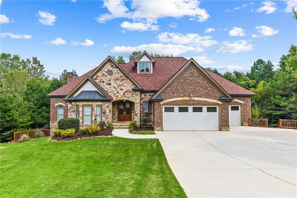 This GORGEOUS high quality home with an elevator has been completely refurbished to amazing condition.The kitchen has all superb quality stainless appliances including a new 6 burner double oven gas range with built in griddle,an amazing high quality infrared exhaust over range,an island with a separate vegetable sink,state of art refrigerator with Keurig attachment,abundant all wood cabinets, and a large walk in pantry room.The master has enormous closet space,a huge tiled double shower with bench,a jetted jacuzzi tub,and more.Everything will remain in the new theatre room including the individual terraced theatre seating,the projector,indirect ceiling lighting, and the wall mounted theatre lights.The mid level entertainment and bar area is beyond expectation. There is over 20' of fabulous solid wood with granite bar(all of the bar stools will remain),dishwasher,full size refrigerator, wet sink,cabinets,etc.The lower level has it's own small kitchen area, a huge bedroom suite, and ample entertainment and relaxation space.The home has 3 open fireplaces, all with gas logs. There are central vacuum systems throughout the entire home.The bedrooms and closets are huge.Most of the secondary bedrooms are as large as many masters.Each level has multiple walk out points to either private deck or patio.The first 2 levels have huge decks that have been completely rebuilt to new condition with all new decking planks and new support posts,bracing,rails,etc.The lower level has a huge flagstone over concrete patio and adjoining walk that are in original new condition.The beautiful extremely wide stairways make a dynamic presentation and facilitate easy navigation.The elevator offers access for everyone to easily navigate the immense square footage.The beauty of this very unique and fully custom design home needs to be seen to fully appreciate the outstanding quality throughout.The convenient Suwanee location close to main highways,restaurants,etc. provides additional value.