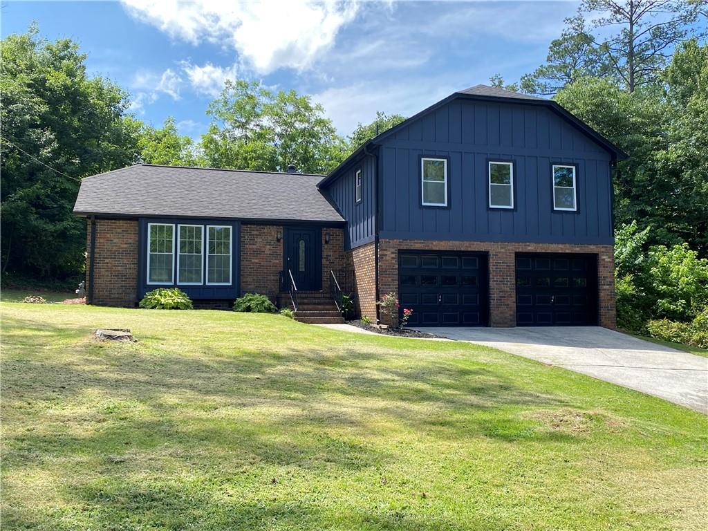 This split-level home with open concept has been completely renovated to perfection. Renovations include all new windows, hardwood floors throughout, new kitchen cabinets with quartz counters, new baths, and more. The quality and attention to detail is rarely found in homes at this price level. The kitchen features an oversized island with quartz countertops, stainless steel appliances, range hood, and Shaker style cabinetry. Family room has a real masonry fireplace. Upstairs has 4 BR, including the spacious primary bedroom which has his/her closets and a connected bathroom with new shower, double vanity, and quartz counters. Step out back to a large, private yard featuring a patio and storage bldg on a large lot with plenty of privacy. This is a modern renovation of a traditional home. Big BR with big closets. You'll love it.