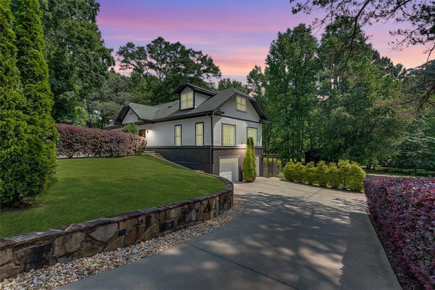 Welcome to this elegant custom-built home filled with natural day light, offering a perfect blend of modern comfort and thoughtful design. The main living area showcases a spacious open-concept layout, featuring a sleek kitchen with stainless steel appliances, quartz waterfall countertops, a large island, pantry, and ample storage, all seamlessly connected to an oversized living room with a wood-burning stone fireplace and an abundance of windows for the natural light to pour in. Two bedrooms, a full bathroom, half bathroom as well as the laundry room and breakfast room all conveniently located on the main floor.  Upstairs, the expansive owners suite offers a serene retreat with a private balcony overlooking a beautifully landscaped backyard and peaceful creek. The finished basement includes a bedroom, full bathroom, and three flexible spaces ideal for a game room, secondary kitchen, fitness area, or additional living space. It also provides direct access to the two-car garage, complete with a clean, durable epoxy floor. The home’s exterior has been freshly painted and features a mix of tile, hardwood, and LVP flooring throughout. The fenced backyard includes an outdoor kitchen and patio, fruit trees, and a fully functioning well for irrigation. Situated on a large level lot with a convenient circle drive, as well as a separate driveway for the garage. This property is zoned to top-rated schools and just minutes from downtown Alpharetta, Halcyon, Avalon, Crabapple, Windward Parkway, and GA-400. With its versatile layout and location, it also presents an excellent opportunity for multi-family rental use.