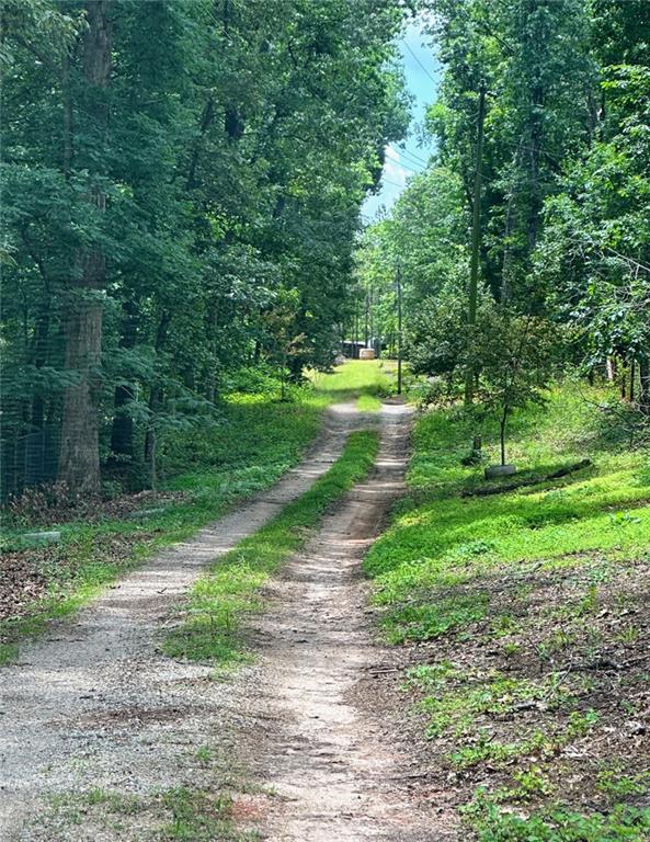 Endless Possibilities on 16+ Private Acres in Douglasville!
Serenity, privacy, and opportunity all meet on this beautiful 16.01-acre property, tucked away at the end of a long, private driveway. Offering a harmonious blend of cleared space and wooded acreage, this land is ideal for a private estate, recreational retreat, or future development.
A natural spring graces the property, enhancing its peaceful, country atmosphere and adding to its unique charm. Included is a mobile home that’s been loved and lived in, providing immediate livable space or rental potential while you bring your vision to life. Whether you build your dream home, create a weekend getaway, or invest in future possibilities, this property delivers a rare combination of natural beauty and practical options.
Investors, builders, and dream-home seekers alike will appreciate this serene setting and the potential it holds — where history meets opportunity and nature never feels far away.
Utilities are already in place — septic, water, and electricity — making it easy to bring your vision to life.
Ideal for:
~Custom home estate or private family compound
~Subdivision for multiple estate-sized homes
~Farm, equestrian property, or hobby homestead
~Recreational use or weekend getaway
Enjoy the peace and privacy of rural living while being just minutes from shopping, dining, schools, and major highways.
Highlights:
~An existing mobile home 2 bedrooms and one bathroom
~16.01 wooded acres with a cleared homesite
~Natural freshwater spring on the property
~Existing septic, water, and electricity
~Minutes to I-20, Arbor Place Mall, Sweetwater Creek State Park, and more
~Limitless potential for personal use, income-producing opportunities, or long-term investment
The imagination is limitless… what will you build?
Up to buyers to check for additional easements and verify all info.