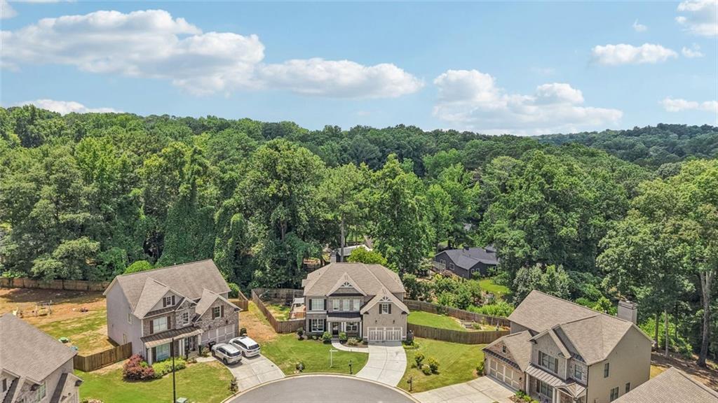 Fantastic Opportunity to Live in the Sought After Hawkins Place Subdivision. This 5BR/3.5 Bath Home is well Appointed with Numerous Upgrades, Bonus Room, Large Fenced Backyard, Covered Patio for Relaxing, Oversized Deck for Entertaining and Sits on a Private Culdesac Lot! This Bright Open Floorplan Has Gorgeous Wide Plank Hardwood Floors Throughout Main. Chef's Kitchen w/Custom White Cabinets, Granite Countertops, Tiled Backsplash, All Stainless Steel Appliances, Built-in Microwave, Dual Ovens, Separate Gas Cooktop, Island, Breakfast Bar, Pendant Lighting, Walk-in Pantry and Breakfast Area w/Chandelier. Dining Room w/Tray Ceiling, Wainscoting, Chandelier and Butler's Pantry. Separate Den/Office Area on Main w/Crown Molding. Family Room with Custom Fireplace, Ceiling Fan and Wonderful Backyard Views. Covered Patio is Perfect for Reading and Relaxing or Entertain on the Oversized Deck Overlooking the Private Fenced Backyard. Large Master Suite Has Tray Ceiling and Fan. Master Spa Has Gorgeous Tiled Floor, Custom Dual Vanity w/Quartz Countertops, Custom Fixtures, Oversized Garden Tub, Subway Tiled Shower and Huge Walk-in Master Closet. Huge Bonus Room Up Makes a Wonderful Rec/Media Room or Potential 5th Bedroom! 3 Spacious Secondary Bedrooms Up, One w/Private Bath and Two Others That Share a Jack-n-Jill! This Home Has Lots of Character and Curbside Appeal! Buyer will Receive a $3,500 Lender Credit with preferred lender JT Trial-Certainty Home Lending