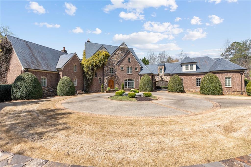 European Estate on Lake Lanier! Surrounded by Lush Landscaping , this home is the epitome of Old World Elegance and Craftsmanship . Custom built from the finest of imported materials and artisans . Hand molded bricks, Slate roof , Copper gutters, down spouts & scuppers , Cast iron fountain ,Turkish Travertine tiles surrounds the Salt Water Pool & Spa, Outdoor fireplace, 3 terrace level entertaining areas and Boat dock. Inside , you will be amazed by the level of detail in every room ~ 30' Coffered ceiling in the formal living room , Handsome hand cut beams in the keeping room , Custom cabinets in the gourmet kitchen , Solid walnut & Copper stamped ceiling surrounds you in the study , Substantial moldings , Slate & Walnut flooring , Arched entrances and doorways , , Hidden doors, grand foyer, 5 bedrooms , 7 bathrooms , Media room , Home gym & Billiard room . 12,000 square feet of finished living space and 5,000 square feet of unfinished storage or room to expand . This Home Is One of A Kind