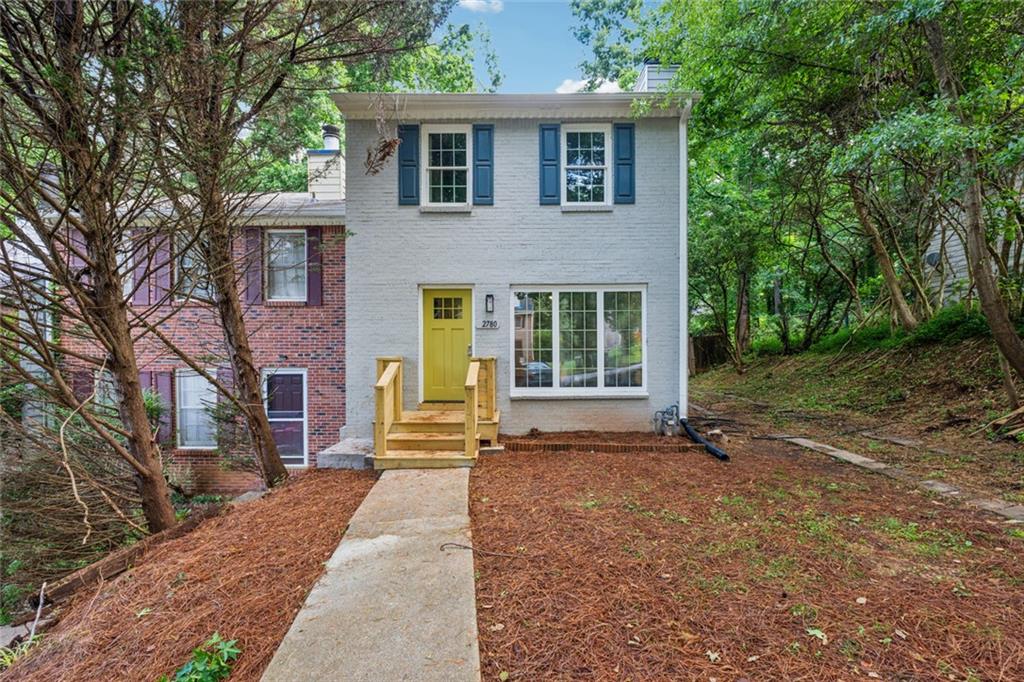 This beautifully updated end-unit townhome features brand-new finishes throughout. Enjoy durable LVP flooring on the main level and plush new carpet upstairs. Large Living Room with a decorative brick fireplace and brand-new windows on either side. Tons of natural light! The kitchen is fully renovated with all-new cabinetry, granite countertops, and stainless steel appliances. Just off the kitchen, step out to a private patio overlooking the massive fenced backyard—ideal for entertaining, pet, and kids. Upstairs there are two large bedrooms which share a fully remodeled bathroom with granite countertops and a brand-new tub/shower and vanity. Located just 5 miles from I-75, with quick access to downtown Smyrna (10 minutes), Marietta Square (14 minutes), and Truist Park/I-285 (15 minutes). No HOA and no rental restrictions—perfect for homeowners and investors!