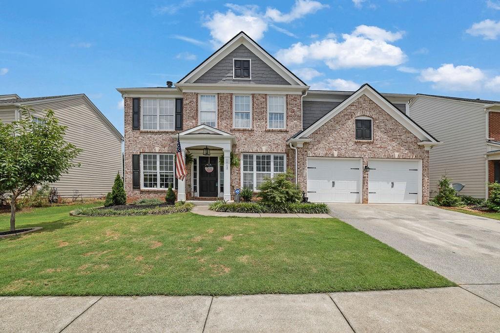 Welcome home to this beautifully updated 4-bedroom, 2.5-bath home in the sought-after Woodland subdivision—just 15 minutes from vibrant Downtown Woodstock and located in the highly rated River Ridge High School district. From the moment you arrive, you’ll notice the charming curb appeal with a manicured front lawn and an inviting rocking chair front porch. Inside, you’re greeted by a two-story foyer flanked by a formal dining room and a versatile flex space—perfect for a home office or additional living area. The heart of the home is the stunning two-story family room with a cozy fireplace, open to a completely renovated kitchen featuring white cabinetry, granite countertops, tile backsplash, stainless steel appliances, a center island, and a bright eat-in breakfast area. A convenient butler’s pantry makes entertaining seamless. The main level is filled with natural light and thoughtfully designed with comfort and functionality in mind. Head upstairs via the back staircase to find four spacious bedrooms, each offering generous closet space. The oversized primary suite boasts tray ceilings and a luxurious en suite bath with dual vanities, a soaking tub, tile shower, and a massive walk-in closet. Step outside to your private backyard oasis with a lush garden, ample green space, and a patio perfect for entertaining, pets, or play. Ideally located near major highways, shopping, dining, and parks, this home also offers access to a rich array of community amenities, including pickleball and tennis courts, a pool, playground, walking trails, and more. Don’t miss this move-in ready gem—schedule your private showing today!