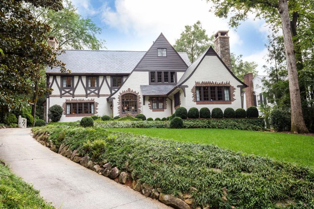 Significant refinements and upgrades in the last 24 months to this fabulous home. 1925 tudor estate built by the family of Joel Chandler Harris, totally restored in 2002-2004 updated to currect standards in 2015. A+ new gourmet kitchen plus logia with iron framed windows and doors opening into the courtyard with pool, and exquisite gardens connecting to the newly renovated guest house and garage. Gracious and inviting everyday living space. Three bedrooms in main home and one full suite in guest house. 8 fireplaces, slate roof, original glass and class.