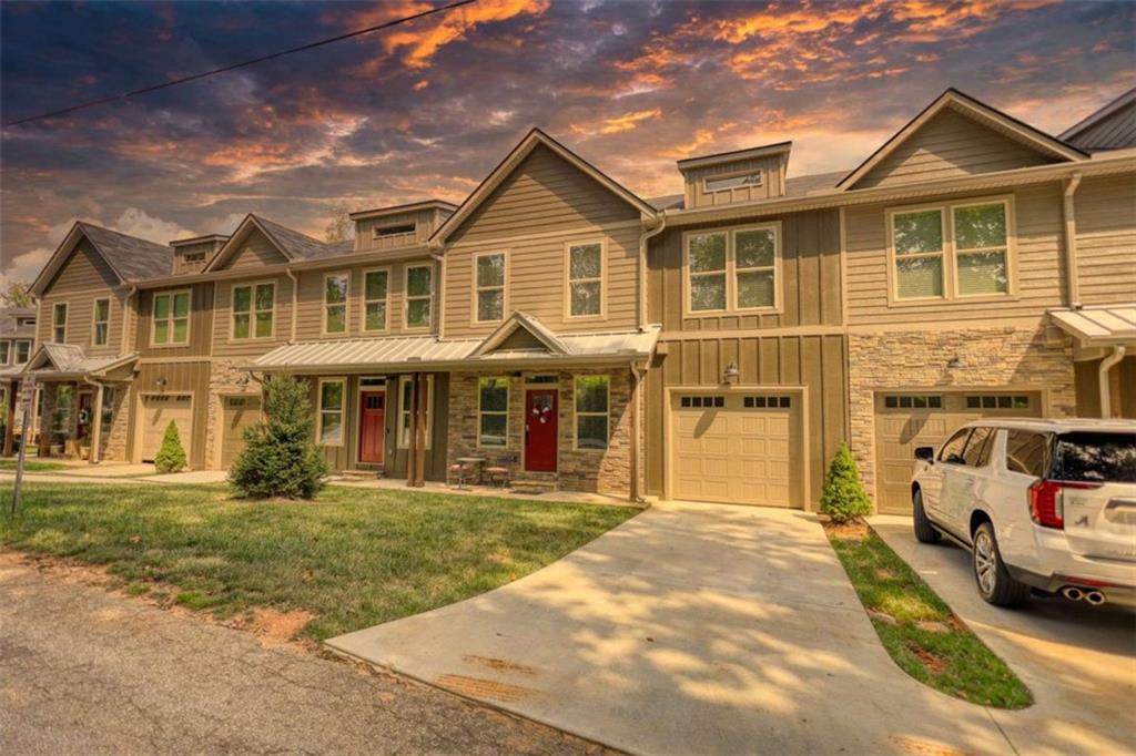 This beautifully maintained 4-bedroom, 3.5-bath townhouse offers a modern and comfortable mountain retreat just half a mile from downtown Clayton. Enjoy the convenience of paved sidewalks that lead straight into town, where shops, restaurants, and local charm await. Built in 2021 and barely lived in, the home features stylish finishes throughout, including a stainless steel dishwasher and range/oven. With three spacious living areas, there's plenty of room to relax, entertain, or unwind after a day outdoors. The recently renovated basement adds even more versatility, while dual one-car garages-one on the main level and another off the basement-offer generous parking for up to four vehicles. Whether you're looking for a full-time residence, a weekend getaway, or a rental investment, this property is a standout option. Located in the heart of a sought-after tourist destination, you're just minutes from scenic trails, waterfalls, and three nearby state parks. Come experience mountain living at its finest in this inviting and picture-perfect home.