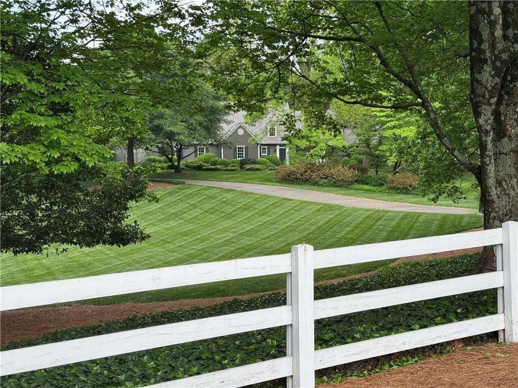 Million dollar price reduction.  2024’s MOST ANTICIPATED LISTING! The Hamptons meets Atlanta. Tucked away on 5.7+ acres with meticulously landscaped grounds.  We have all driven by this one and admired the white board fencing and lawns surrounding the home.  The main house consists of 6 bedrooms, 4 full baths and 2 half baths.  Formal living room, dining room, vaulted family room with masonry fireplace and more than one study.  Walk out backyard with French doors opening to the pool terrace and formal gardens are designed with entertaining in mind.  The west lawn was once the site of a tennis court and the south lawn is where the stable once stood housing the family's horses. Renovated and expanded in 1995 this home has been meticulously maintained. 

Featuring a guest house above a 4 car garage with a kitchenette 2 additional bedrooms, large living room and 2 full bathrooms.  Bedrooms are shown as lower level room count.  

A rare opportunity to own this iconic home can be yours!