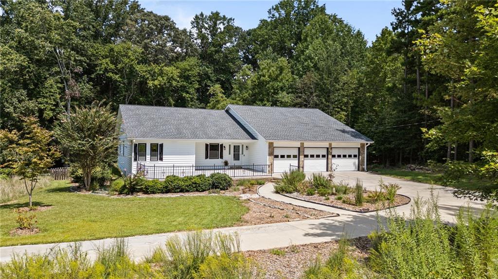 This spectacular east-facing ranch proves you really can have it all—style, space, privacy, and Lake Lanier living without the HOA drama (because who needs a committee telling you where to park your boat?). Fully renovated and move-in ready, it even comes with all appliances—so instead of waiting for a Home Depot delivery, you can head straight to planning your first boat day. Walk to Bald Ridge Campground or zip 3 miles to Tidwell Park & Boat Launch and slide right into South Lake Lanier. With parking for your boat, RV, jet skis, and every other oversized toy you’ve collected, weekends practically throw themselves a party. Speaking of parties—the outdoor living here is begging for string lights, good music, and a group chat titled Patio Vibes Only. Or, if you prefer a quieter scene, the oversized sunroom is ideal for sipping coffee…or cocktails…while you spy on the wildlife wandering past your fenced backyard. Inside, the open floor plan brings the drama (the good kind) with soaring ceilings and custom finishes. The kitchen is so big it could double as the set of a cooking show, complete with quartz countertops, stainless steel appliances, custom cabinetry, and an island large enough to host a charcuterie spread that could feed all of Forsyth County. The main-level primary suite is basically a private spa—with its own fireplace and a marble walk-in shower featuring dual shower heads (yes, dual, because one is not enough). Downstairs, the finished terrace level is the ultimate hangout: a wet bar, office, massive media room, and a private suite with a full bathroom. The terrace level has its own entrance from the garage, and it can double as a standalone apartment: Translation: perfect for in-laws, adult kids, or your new side hustle as a landlord. With a 4-year-old roof and gutters, a 4-year-old deck, a newer septic system, and a laundry list of upgrades, you’ll have more time for lake life and less time calling contractors. All this, just minutes from GA-400, the new Cumming City Center, Northside Forsyth Hospital, shopping, and the North Georgia Mountains. 4050 Vintage Court isn’t just a house—it’s your new headquarters for boating, brunching, and unapologetic relaxing.