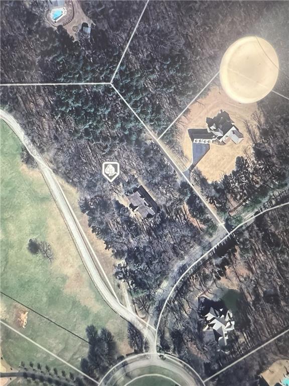 5.92 acre Estate home site inside the gated Woodhaven Bend subdivision on the Etowah River. This lot has a fabulous existing barn that features a small living area and a half bath on the property that is ready for a conversion to a barndominium or build your estate home on the lot and have the barn for recreational purposes, car collections, horses, or guest house. The possibilities are endless. Woodhaven Bend is a gated sanctuary of 32 custom Estate home sites. This peaceful community offers, walking and riding trails, a boat ramp for access to the Etowah River, and beautiful rustic pavilions along the nature trails for community events and enjoyment. Centrally located near Ball Ground, Canton, Woodstock, Milton, Cumming and Dawsonville. Come and see this beautiful lot and Barn and think of all the options for your dream home.