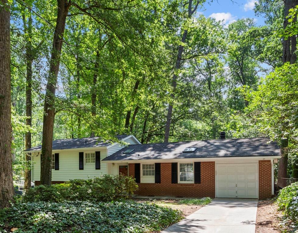Fantastic opportunity to own in the Historic Northcrest Neighborhood! This house has been well loved and cared for and is now ready for YOU to make it your own! Original Hardwood floors in all three bedrooms and the living room- skylights in the foyer and kitchen bring in lots of natural light.
This 4 sided brick Split Level sits on almost a half acre lot. Lined with mature trees, your back yard is private and secluded and perfect for playing, entertaining, gardening and relaxing. Pull up your Adirondack and entertain friends with cornhole, play fetch with the doggo or just watch the stars above the firepit, there's plenty of backyard space for it all!
Head on over to the community's own private Northcrest Swim and Tennis club to hang out with neighbors, swim laps at sunset or enjoy a tennis match.
Situated near 85N & 285 it's easy to zip anywhere in the city, but tucked away from the hustle and bustle from the highways. Convenient grocery Shopping and amenities just down the street. Enjoy nearby Downtown Tucker restaurants, live music and activities. Local Buford Farmer's Market & Buford Hwy restaurants are not to be missed.