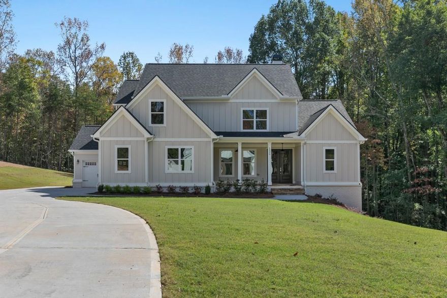 Set on 6.42 private acres near Lake Lanier, this new construction opportunity at 3 Henry Pirkle Dr. in Dawsonville offers the rare chance to design your home from the ground up. Buyers can fully customize the architecture, layout, materials, and finishes to match their vision-whether modern farmhouse or classic Southern design. The attached photos show a completed build of this plan, featuring bright open living spaces, a large chef's kitchen, elegant bath design, and an inviting covered deck with a fireplace overlooking wooded views. Conveniently located near the lake, parks, and Dawsonville shopping, this homesite combines privacy with accessibility and the freedom to create a truly personalized retreat.
