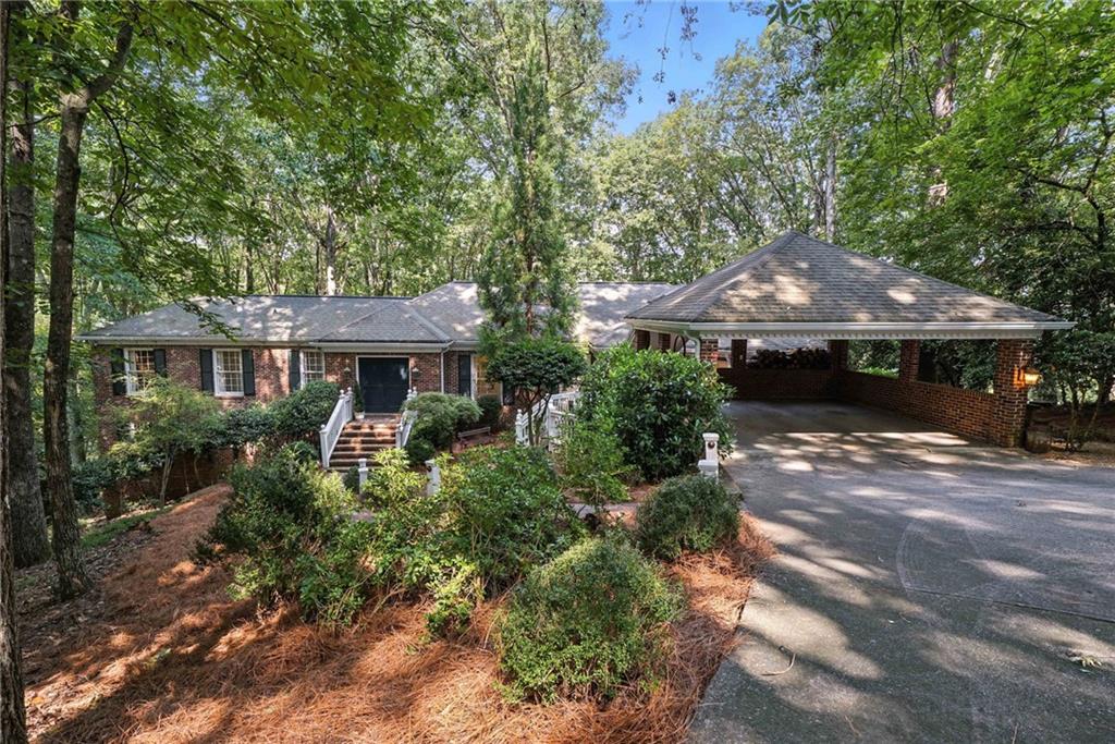 Rare Privacy and Convenience in this river estate. You’ll feel at home in the wooded setting which hosts dramatic views. Multiple wonderful spaces for entertaining. Located on a large lot in desirable Huntcliff neighborhood - including Huntcliff River Club - a swim, tennis and equestrian community on the Chattahoochee River. Located minutes from Sandy Springs and downtown Roswell which are both shopping, entertainment and dining hubs of activity. Also positioned minutes from GA400 and between Buckhead and Alpharetta. This all-brick home features 4 Bedrooms, 2-1/2 Baths, high ceilings, hardwood floors, beautiful millwork, large rooms, picture windows and a terrific floor plan. The Main Level features an Entrance Foyer, large Living Room and Dining Room with River views, a cozy Study with fireplace and built-in shelving plus a private Powder Room. The Kitchen features two pantries, custom cabinets, a desk space, an island with 5 burner GE Monogram gas cooktop, KitchenAid double oven, Whirlpool dishwasher, Samsung refrigerator. Wet bar with wine rack and Breakfast Area set in a Bay Window. The Primary Bedroom includes two closets and a newly remodeled Bathroom with soaking tub, double shower and double vanities. The second Bedroom can function as a dressing room to double the size of the Primary Suite! The Lower Level connects to the main level seamlessly with a main stairway and a back stairway to make this exciting entertainment level function beautifully with the floor plan. The Lower Level features a Wine Storage display cellar with frameless glass doors, large Rec Room with Wet Bar (including Newair refrigerator drawers and Edgestar dishwasher) and gaming / dining area opening to the outdoor Terrace with more views to the River. There are also two bedrooms, a fully remodeled bathroom, a large laundry room and a separate exercise room. The home has lots of storage space, big closets, an Aqua Pure water filtration system, New Trane HVAC in 2025 and 2 year old hot water heater. This home has the features that people love plus nearby Huntcliff River Club, Azalea Drive, Atlanta Rowing Club, Nantahala Outdoor Center, Chattahoochee Nature Center, Publix, Roswell Riverwalk Trail, Go With It Farm horseback riding, Morgan Falls Overlook Park, and Bull Sluice Lake. Don't miss this one!