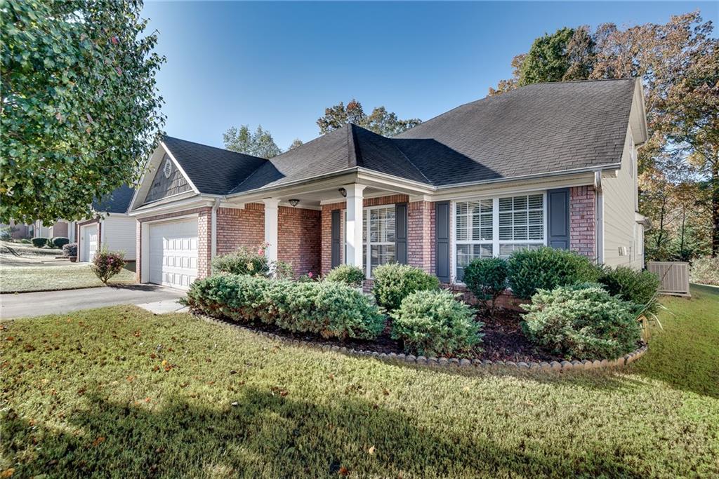 Welcome to this spacious ranch home, offering a perfect blend of comfort and warmth. Boasting 3 bedrooms and 2 baths on the main level, including a well-appointed owner's suite, this home features a thoughtful open layout ideal for both family living and entertaining. Off the foyer with raised ceiling, you will find flex space with a tray ceiling and beautiful crown molding. The chef's kitchen, featuring ample storage and counter space, breakfast bar, and separate dining area opens to the inviting fireside great room with soaring ceilings, creating a bright and airy space ideal for both relaxing and entertaining. Natural light pours through large windows of the dining room, creating a welcoming atmosphere. The bright sunroom offers a peaceful retreat, perfect for relaxing with a cup of coffee or enjoying the outdoors year-round. Beautiful site-finished hardwoods flow throughout the main living areas, adding warmth and character to the home. Upstairs, you'll find a private loft area that leads to an additional bedroom and full bath, offering versatility for guests, a home office, or a growing family. This home provides ample space and timeless charm, with thoughtful design and a functional layout that will meet all your needs. Come see why this could be your perfect place to call home!
