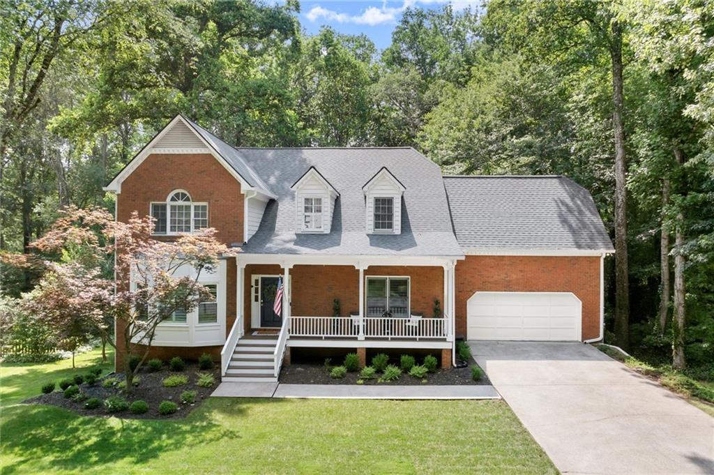Discover this beautifully updated home in sought-after Windsor Oaks, a premier East Cobb swim and tennis community known for its vibrant amenities and award-winning schools. Set on a large, professionally landscaped flat lot with room for a pool, this 6-bedroom, 4-bath home offers modern comfort, designer finishes, and seamless functionality throughout. The welcoming front porch leads into a light-filled interior featuring 9-foot ceilings, wide plank hardwood floors, custom millwork, and stylish lighting. The open-concept layout is ideal for today’s lifestyle with multiple living and dining areas, and several work-from-home options, including a dedicated office with built-ins, a main-level study, and a private office nook in the primary closet. You will love every inch of this home that has been thoughtfully updated with high-end finishes and HGTV-worthy design. The chef’s kitchen is the heart of the home with high-end cabinetry, granite countertops, under-cabinet lighting, stainless steel appliances, a gas cooktop, pantry, and bar seating, flowing seamlessly into the fireside family room. Step outside to an expansive entertainer’s deck with peaceful views of the flat backyard, ready for a future pool, garden, or play area. A full bedroom and beautifully updated bathroom on the main level offer a private retreat for guests or extended family. Upstairs, the oversized primary suite features a cozy gas fireplace, tray ceiling, and multiple custom walk-in closets. The luxurious ensuite bath includes a quartz double vanity, soaking tub, marble tile, and premium fixtures. Three additional bedrooms share an updated bathroom with three sinks, two of which are conveniently located outside the main bath for easier mornings. A bright upstairs laundry room adds extra function. The daylight, walkout terrace level is designed for flexibility, offering a spacious media or rec room, private bedroom and full bath, and a large unfinished area ideal for storage, a workshop, or future expansion. Additional highlights include newer roof, HVAC systems, smart thermostats, updated hardware and lighting, and extensive built-in storage. The community amenities include four new tennis courts, a pickleball and basketball court, two pavilions, playground, and a pool, all just minutes to top-rated schools, shopping, and parks. This is more than a house, it’s a forever home for families who want space, style, and a sense of community. Don’t miss your opportunity to own this beautifully updated home in one of East Cobb’s most desirable communities!