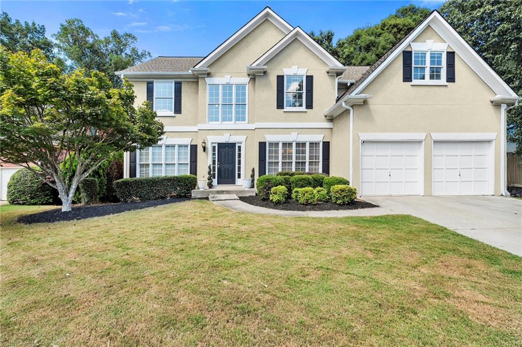 Desirable Grovehurst subdivision in the Walton High School district. Spacious and bright hard coat stucco with 3 sides concrete siding, 6 bedroom and 4 full baths, full finished basement, and private backyard with room for a pool. Enter the 2 story foyer overlooking the spacious living room on one side and the separate dining room that seats 12+ on the other side. Two story fireside family room overlooking the spacious chef’s kitchen with granite countertops, tile backsplash, stainless steel appliances including refrigerator and gas 5 burner stove with hood, microwave, and dishwasher. Bedroom suite on the main with full bath plus a large laundry room with sink that includes washer and dryer. Upstairs boasts a monster primary suite with sitting area, double vanity, separate shower, jetted tub, and huge walk-in closet. Three additional bedrooms and a full bath complete this level. Finished terrace level has library or bedroom, media area, game room, full bath, and kitchenette plus additional storage. Large deck overlooking a private backyard with room for a pool. Top Schools, low HOA fees, and convenient to shopping and dining. This is a lot of house for the money!