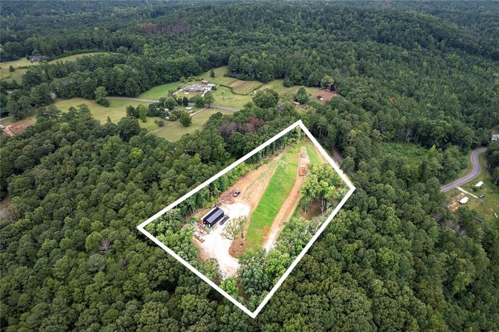 Discover the perfect canvas for your dream home on this stunning 2.8-acre parcel in the heart of Dallas. Set in a peaceful location with a paved driveway for easy access, this property offers sweeping views and a serene natural backdrop. Just steps from local wildlife, you’ll enjoy a daily connection with nature while still being close to all the conveniences of town. Whether you envision a private retreat or a custom-built residence, this land provides the ideal blend of seclusion, beauty, and accessibility. Enjoy expansive views that capture the beauty of the surrounding landscape, along with the rare opportunity to observe deer, birds, and other wildlife right from your future porch. The gently rolling terrain provides an ideal building site, giving you flexibility in home design and orientation to take full advantage of the scenery. Nestled atop the landscape is a 40X18 metal building , equipped with a convenient garage door and a cozy office space, providing a head start for projects or storage needs. Detailed house plans are readily available as well as utilities, making the permit application and building process smoother and more cost-efficient. Whether you’re dreaming of a private country retreat, a hobby farm, or a custom residence with room to roam, this property offers the perfect balance of privacy, natural beauty, and convenience.