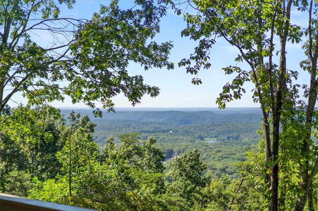 Welcome to 157 Sunrise Terrace, a charming and serene mountain retreat nestled in the prestigious gated community of Bent Tree. This cottage-style home, perched on a lush, wooded 0.53-acre lot with seasonal mountain frontage, offers a warm and inviting living space anchored by a cozy fireplace - perfect for relaxing evenings or entertaining. Light floods the main living area through a wall of large windows and sliding glass doors, beautifully framing long-range mountain views from nearly every angle. The custom kitchen features cherry wood cabinets, granite countertops, and a breakfast bar that flows into an open floorplan ideal for gathering. Two bedrooms and 2 ½ baths include a convenient master-on-the-main layout, while the fully finished terrace level (complete with a second kitchen and laundry) opens to its own lower deck - offering in-law suite potential, bonus living, or versatile storage and hobby space. Set within more than 3,500 acres of natural beauty, Bent Tree residents enjoy an unmatched mountain lifestyle with access to a Joe Lee-designed 18-hole championship golf course; a pristine 110-acre stocked lake for fishing, swimming, or kayaking; multiple pools; indoor and outdoor tennis and pickleball courts; miles of scenic hiking trails; equestrian facilities; a dog park; bocce; clubhouse dining; and year-round social events. With no rental restrictions, this property is also an incredible investment opportunity. Residents benefit from 24/7 gated access, on-site fire and public safety services, and reliable utilities - this is more than a home, it’s an elevated lifestyle. Whether you're seeking a peaceful retreat, a cozy primary residence, or a turnkey income property, 157 Sunrise Terrace embodies the perfect blend of mountain charm, functional living, and resort-style amenities that make Bent Tree truly special.