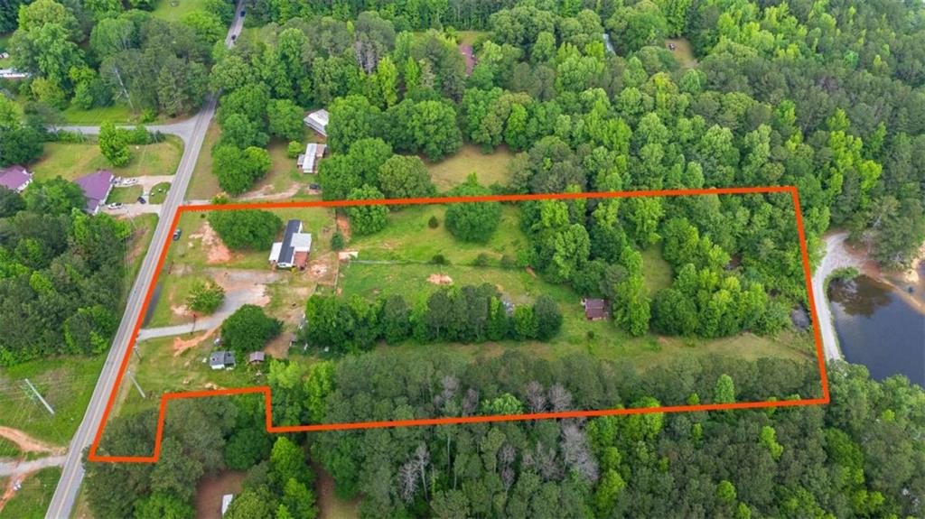 Stunning 6-Acre Property Overlooking Lake Paradise! Discover the beauty and potential of this nearly 6-acre farm with beautiful views of Lake Paradise. This incredible property offers the perfect blend of natural serenity and practical convenience. A cute red barn adds rustic charm with stables for livestock, or valuable storage or workspace, while a manufactured home is already in place-ready for your personal touch or to live in while you build your dream home. With power, county water or well water, and septic already installed, the groundwork is done. Whether you're seeking a peaceful retreat, a hobby farm, or the ideal location to create your forever home, this land is ready to bring your vision to life. Enjoy direct access to Lake Paradise Park, a city-owned gem just steps away, where you can fish, kayak, and soak in the peaceful lake surroundings year-round. Conveniently located with easy access to I-20 and just minutes from Villa Rica's restaurants, shopping, and hospital, this property offers both seclusion and accessibility. Don't miss this rare opportunity to own land with incredible views, recreational access, and so much potential!