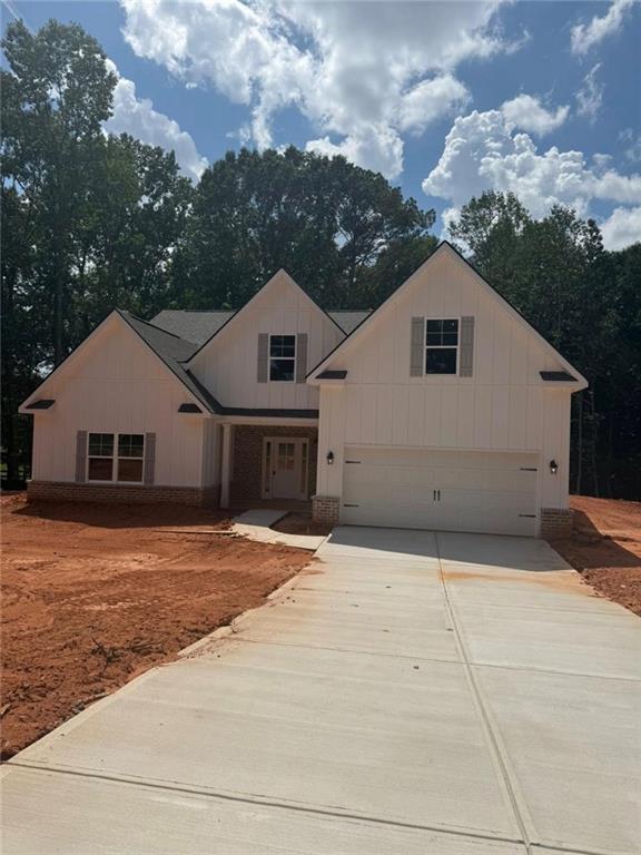 Experience peaceful living in this brand-new 4-bedroom, 3-bath ranch-style home nestled on 2.02 acres in beautiful Jackson County. With 2,842 square feet of open-concept living, this thoughtfully designed home features a spacious front and backyard, professional landscaping, and a wooded backdrop for added privacy. Enjoy a light-filled open floorplan with the primary suite conveniently located on the main level, complete with oversized walk-in closets and a beautifully tiled master bath. Laundry room on main. Modern finishes, generous living spaces, and a seamless indoor-outdoor flow make this home perfect for both everyday comfort and entertaining. Move-in ready and built for easy living-your dream home awaits. *Professional photos will be uploaded Friday*