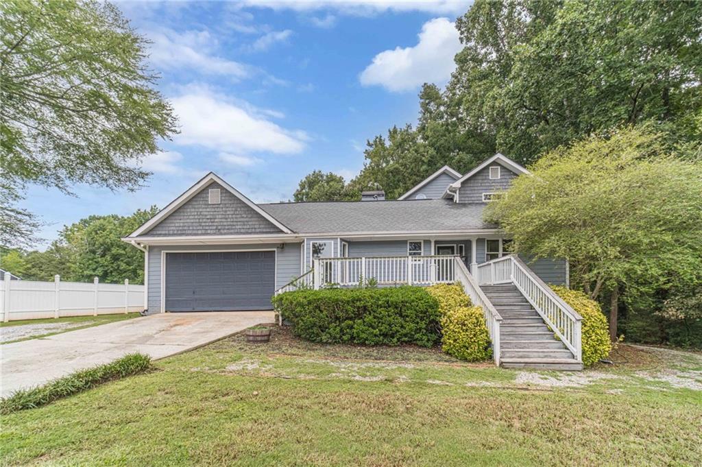 Welcome to your private retreat on over 2 acres in Monroe! This beautifully maintained 4-bedroom, 3-bath home offers the perfect blend of comfort, space, and versatility. As you step inside, you're welcomed by a light-filled foyer that leads into the expansive great room, featuring soaring ceilings with beams that create a warm, open, and inviting atmosphere with views to your beautiful backyard. The kitchen offers granite countertops, ample cabinetry, a breakfast nook and open concept dining area that flows seamlessly into the main living spaces ideal for everyday living and entertaining. The main level hosts Two secondary bedrooms, a full bath, and a spacious flex room perfect for an office, playroom, or additional living area. Upstairs, you'll find the private primary suite, which includes a generously sized bedroom and a spa-inspired bathroom with dual vanities, soaking tub, and separate shower. The finished basement offers incredible potential as a mother-in-law suite, rental opportunity, or multi-generational living space featuring a kitchen, full bathroom, bedroom, and its own private exterior access. Step outside and experience your own private resort. Situated on over 2 acres, the property features wraparound decking that seamlessly connects the home to its expansive backyard oasis. Whether you're hosting a summer gathering or enjoying a quiet afternoon, the in-ground pool is the centerpiece of the outdoor living space surrounded by ample patio space perfect for lounging, grilling, and entertaining. Lush green space provides room to roam, while mature trees offer privacy and natural beauty. The private deck off the primary suite gives elevated views of the backyard and pool, creating a peaceful spot to enjoy morning coffee or evening sunsets. There's even space for a garden or firepit. With a combination of open lawn, shaded areas, and thoughtful landscaping, the outdoor environment is equally suited for lively gatherings or peaceful solitude. Conveniently located near Monroe, Bethlehem, and Loganville, this one-of-a-kind property offers the best of both worlds: peaceful country living with easy access to shopping, dining, schools, and major highways.