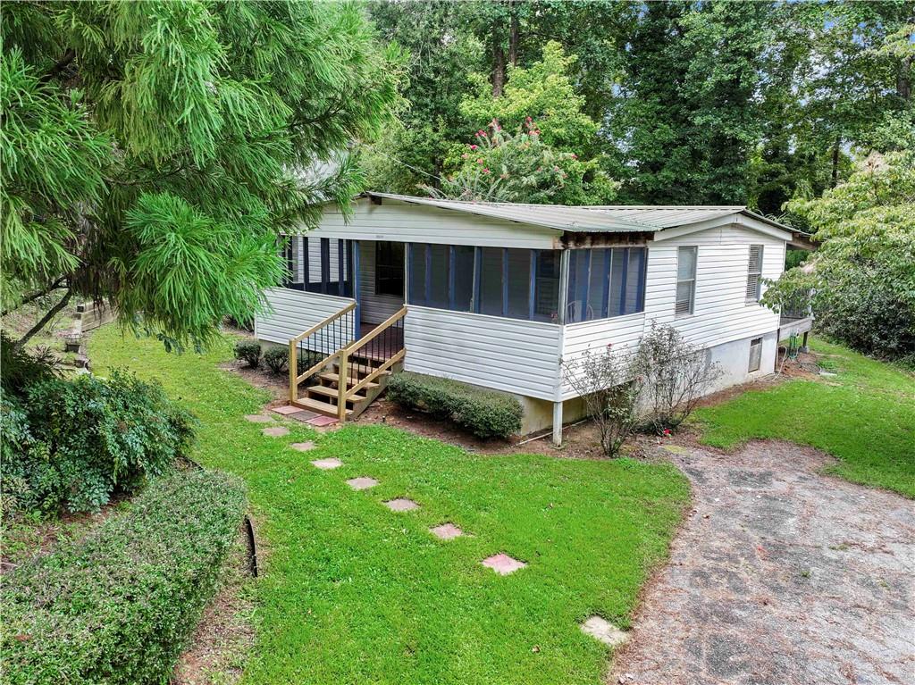Charming and affordable 3 bedroom, 1 bath mobile home with incredible potential. This home is in good condition and ready for your personal touch. Enjoy a private backyard, perfect for family gatherings, gardening, or simply relaxing outdoors. The oversized driveway accommodates up to 4 vehicles, making it convenient for guests and multiple drivers.
Located in a welcoming community, you’ll have access to lakefront activities, a swimming pool, and a playground, all included with a low $60 monthly lot rent that covers your water bill. This is a rare opportunity to own an affordable home with great amenities, low monthly expenses, and room to make it your own. With a little vision, this home can be transformed into a cozy retreat or an excellent investment.