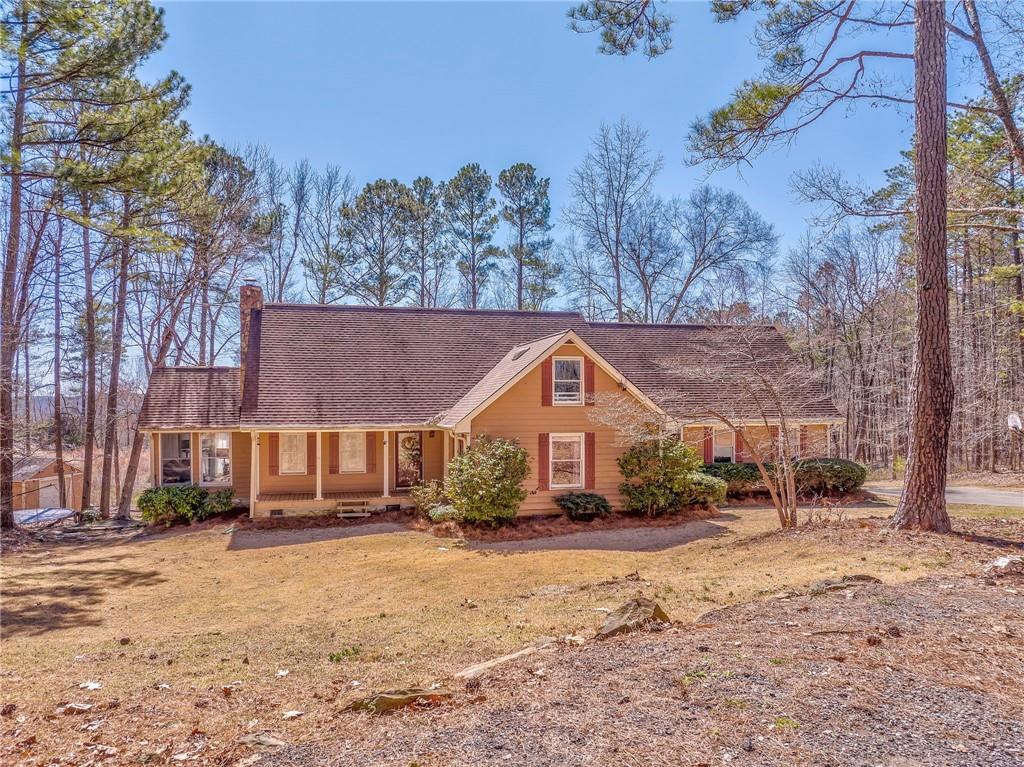 A rare find nestled in North Paulding on a peaceful country road with a vast amount of road frontage and an inviting horseshoe shaped driveway. If you're looking for an abundance of space, this home is for you. This beauty has 4 large bedrooms with the master on the main, a bonus room, and a loft. You will fall in love with the recently updated kitchen loaded with upgrades such as, stainless steel appliances, granite countertops, beautiful cabinetry, and an oversized island with seating. This home has additional features that include new flooring on the main level, a large walk-in pantry, a wood burning stove in the kitchen and a fireplace in the cozy family room, as well as a bright and relaxing sunroom, plenty of outdoor storage with the additional shed/storage building. The outdoor living is just as impressive offering a huge back deck overlooking this gorgeous property, the perfect place to entertain or relax in the hot tub. There is also a fully functional pasture that's completely fenced in and ready for a mini farm of your own, as well as a beautiful chicken coop and a raised garden. Situated in a quiet rural area but within minutes of the heart of downtown Dallas and Cartersville.