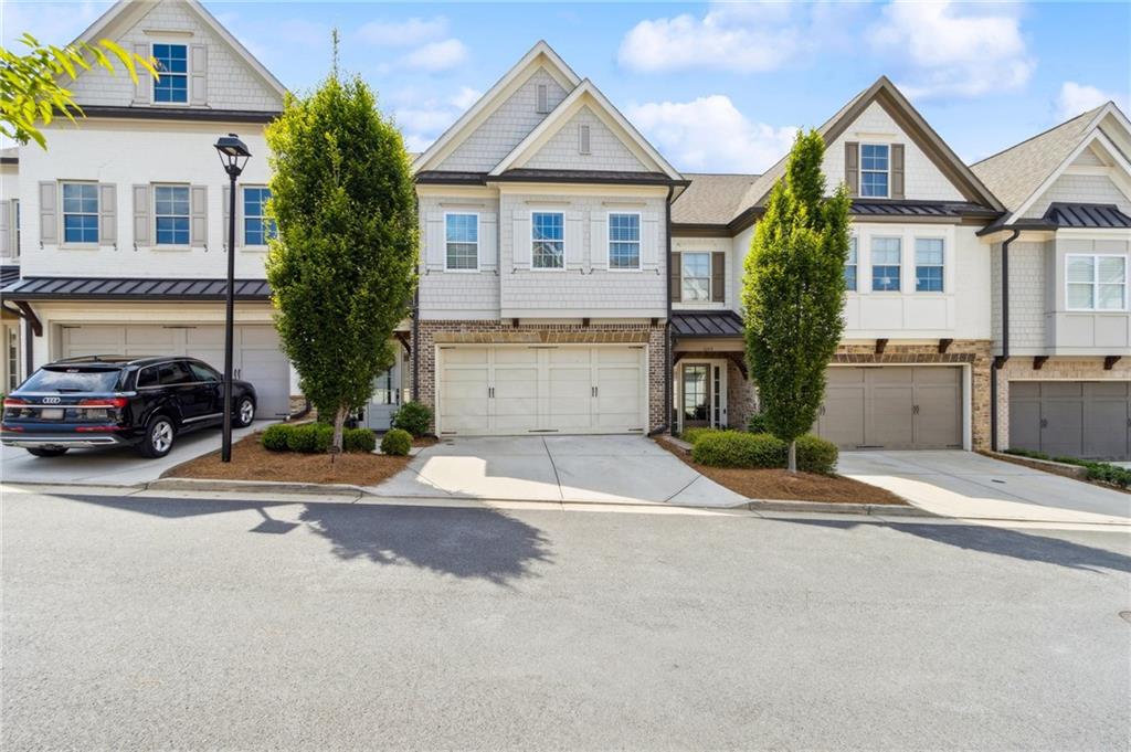 Welcome to 1241 Hightower Crossing in Marietta, Georgia — a stunning and VERY upgraded townhome that seamlessly blends luxury, functionality, and distinctive design. The heart of the home is a chef’s dream kitchen outfitted with premium Thermador appliances, including a brand new 36” x 84” built-in refrigerator, a 36” gas cooktop, oven/microwave combination, and a whisper-quiet dishwasher. The elegance continues with a 45.5” x 123” solid quartzite countertop, anchored by a Kohler Whitehaven 3/4 low divide porcelain farmhouse sink, purified top hat ice from a Scotsman Ice Maker, and pristine water from a MaxiFlow purification system. The walk-up dry bar exudes sophistication with a Thermador beverage fridge, an architectural travertine stone wall, and leather-accented cabinetry, while the morning pantry bar stuns with Summit double freezer drawers and reclaimed Amish Pennsylvania barnwood shelving on a Turkish travertine backdrop.
The kitchen's Soho Studios Baroque crackled ceramic mosaic tile backsplash with Asian Statuary Lines perfectly complements the brushed nickel hardware. Bali Solar Shades ensure privacy while letting in natural light, and cedar-wrapped ceiling beams, seven chandeliers, and three stylish fandeliers add a warm and elevated ambiance throughout. The powder room is a statement of modern elegance with a piano black vanity and etched mirror. Upstairs, the second floor showcases beautiful hardwood flooring throughout, with spray-foam insulation in the attic ensuring energy efficiency and comfort year-round.
The primary suite is a luxurious retreat, complete with a free-standing soaking tub, a dedicated glam zone for hair and makeup, and a Kohler Karing bidet installed in January. Every detail in this exquisite home has been thoughtfully curated for discerning buyers seeking comfort, innovation, and elevated design in one of Marietta’s most desirable locations. Here you’ll find the convenience of being right next to the Marietta Square with restaurants and shopping galore, and Kennesaw National Park.