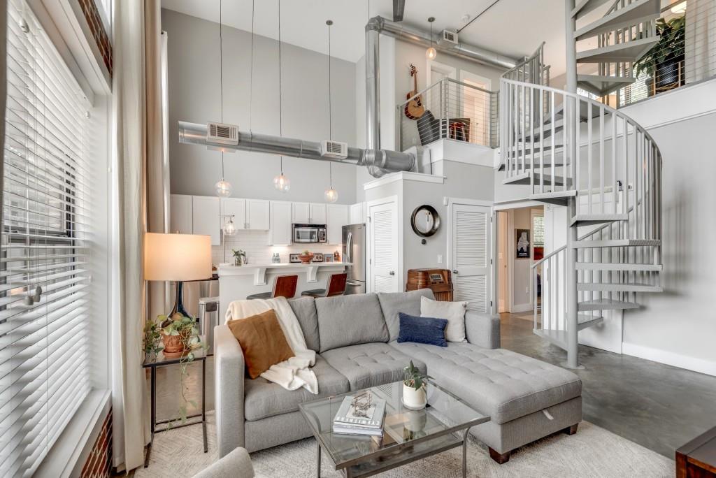 Welcome home to this exquisite 2 bedroom, 2 bathroom condo in a secure gated community right in the heart of Reynoldstown. If you're looking for walkability, then this property is for you - it's steps away from the Beltline, Krog Street Market, Breaker Breaker, dozens of top restaurants, and more. Designed for both comfort and flair, this open-concept 3-story unit boasts tons of natural light, floor to ceiling windows, a cool industrial aesthetic, and an amazing rooftop terrace with sweeping views of Midtown & Downtown. As you make your way through the front door, you are greeted by polished concrete floors, updated lighting throughout, a family room with soaring 24' ceilings, and beautiful exposed brick walls. You will love cooking in this updated kitchen that contains a large island/breakfast bar, quartz countertops, subway tile backsplash, stainless-steel appliances, and white cabinets with under-cabinetry lighting. A hallway off the kitchen leads to a spacious bedroom, which includes a walk-in closet and renovated ensuite bathroom equipped with a new vanity, updated lighting and mirror, subway tile backsplash, quartz counters, floating shelves, and a tub/shower combo. Rounding out the main floor is a laundry closet with a stackable washer & dryer and an oversized balcony that's perfect for winding down after a long day at work. Make your way up the stairs to the 2nd floor, which contains a bedroom/flex room/office. This space also includes another walk-in closet and updated ensuite bathroom highlighted by a new vanity, updated lighting and mirror, and a large glass-enclosed tiled walk-in shower. Save the best for last - head up to the 3rd floor rooftop to spend time on the newly built deck (July 2024) that provides breathtaking skyline views of the city. The rooftop provides outdoor living space that's perfect for entertaining guests, watching gorgeous sunsets, drinking your morning coffee while watching the sun rise, etc. Two deeded parking spaces are included with this unit, in addition to access to two saltwater pools, hot tub, newly remodeled fitness center, clubhouse, business center, and dog park. The location couldn't be better - minutes from Inman Park, Grant Park, Kirkwood, Cabbagetown, East Atlanta Village, Edgewood Retail District, Virginia Highland, Little 5 Points, Downtown, Midtown, and more. Come make this your next home :)