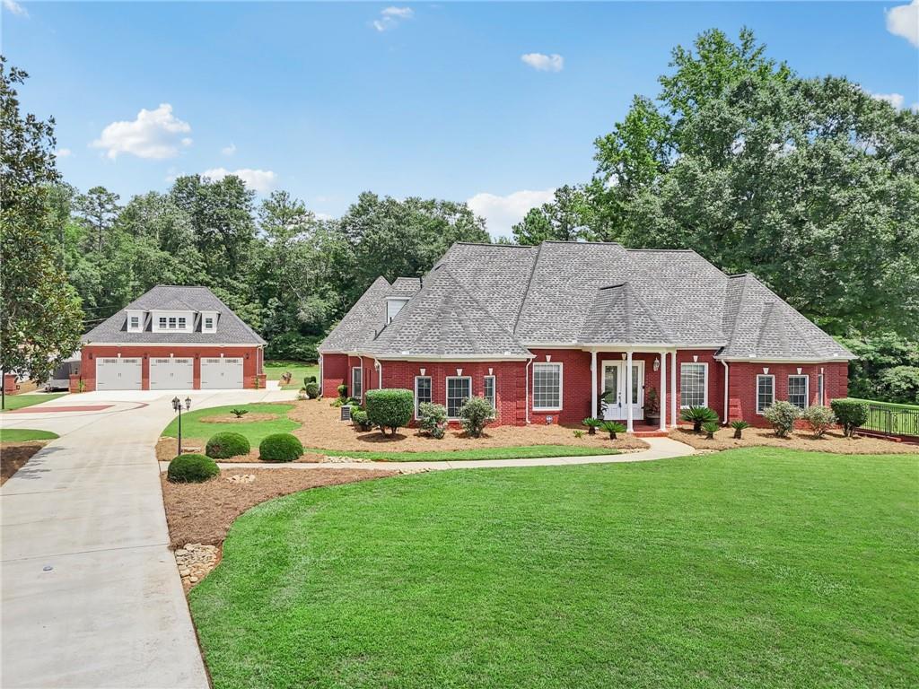 Secluded Luxury on Nearly 3 Acres – A Grand Stone Mountain Estate
Beyond the gated tree lined entry and private drive awaits this exquisite 7,846 sq ft custom residence—an exceptional blend of elegance, privacy, and modern functionality. Perfectly positioned on 2.79 lush acres with no HOA, this executive estate offers the rare freedom to live expansively.
The main residence is designed to impress, featuring soaring ceilings, generous natural light, and refined finishes throughout. A chef’s kitchen anchors the home, opening seamlessly to multiple living and entertaining spaces. The fully finished terrace level offers a fresh, flexible layout ideal for a home theater, fitness suite and multigenerational living.
Outdoors, expansive ground level and suite level decks overlook manicured park-like grounds that invite both grand entertaining and tranquil retreats. Car collectors and creatives will love the five-car garage capacity—including a detached, climate-controlled three-car garage with a fully outfitted guest studio, perfect for in-law living or high-yield rental potential.
Whether you’re seeking a private compound, a multigenerational sanctuary, or a sophisticated home with income opportunity, this gated estate is a rare offering where luxury and lifestyle meet.