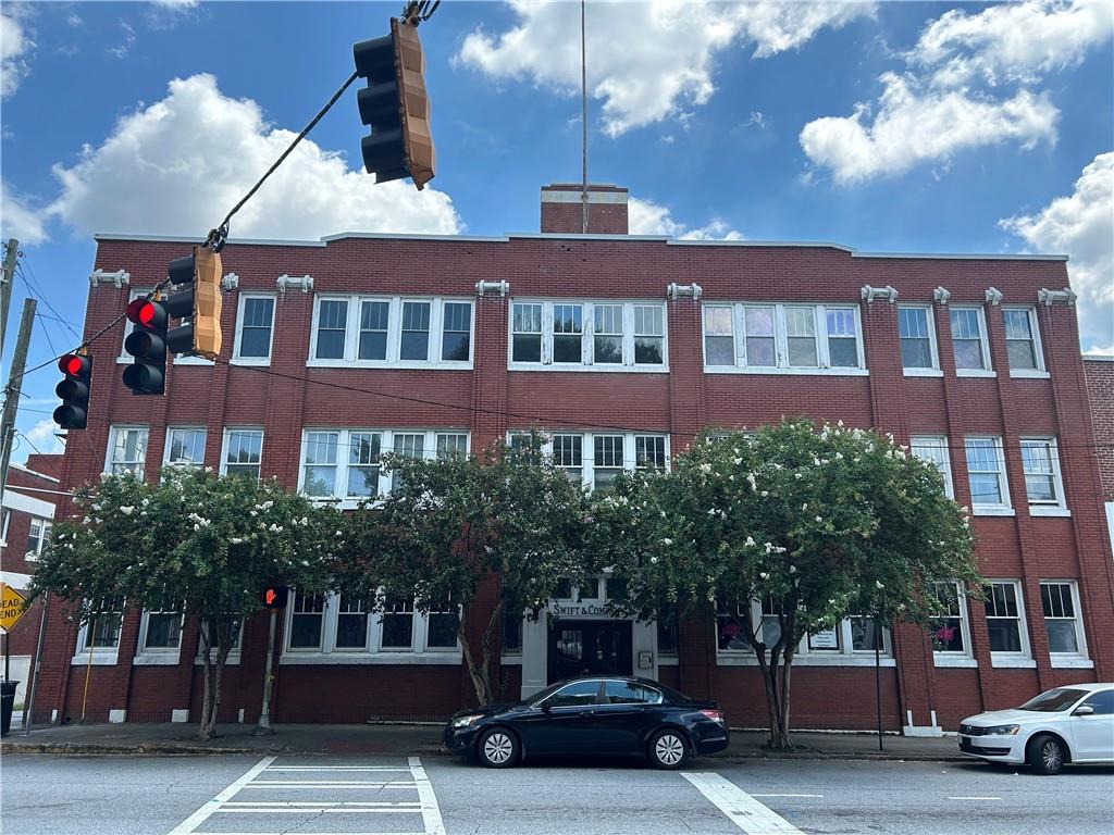 Live in the heart of Atlanta’s vibrant Castleberry Hill Arts District! This 1BR/2BA, 1,800 sq ft loft in the historic Swift & Co. building offers soaring ceilings, exposed brick walls, concrete floors, and industrial-style beams and ductwork for authentic loft living. Massive windows flood the open-concept space with natural light- highlighting the spacious kitchen with sleek cabinetry, modern appliances, and expansive island. Spiral stairs lead to the rooftop with 360 degree views. The primary suite features a spa-like bath with soaking tub combined with open shower and ample closet storage. Additional features include a second full unfinished bath, in-unit laundry hookups, and unique architectural details throughout. Enjoy secure entry, and gated parking just steps from the unit. Enjoy all that Castleberry Hills has to offer- from Mercedes-Benz Stadium, State Farm Arena, restaurants, galleries, and nightlife. Bank-owned foreclosure, sold as-is—ideal for buyers ready to customize and restore this impressive loft to its full potential.